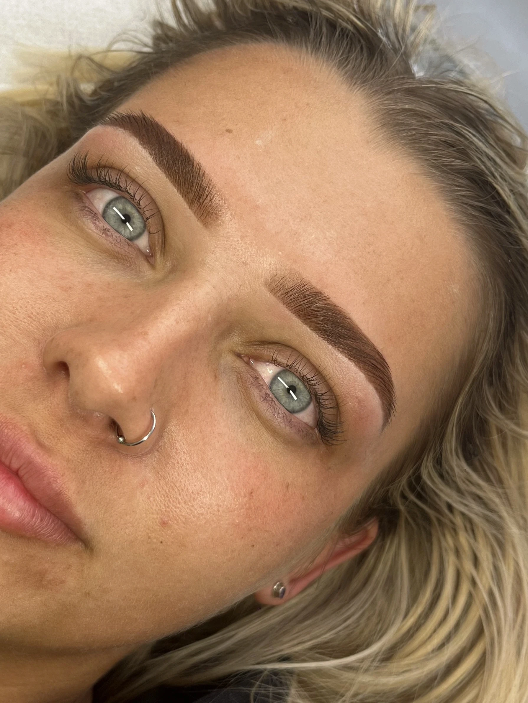 Client with blue eyes modelling the very soft Soft set eyelash extensions