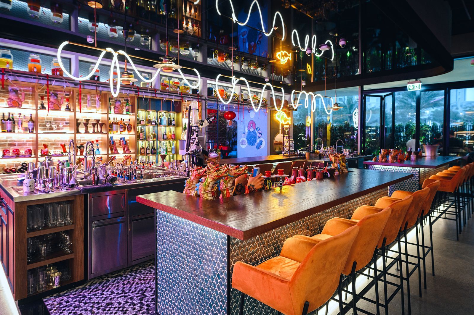 Modern bar with dragon decor and orange stools