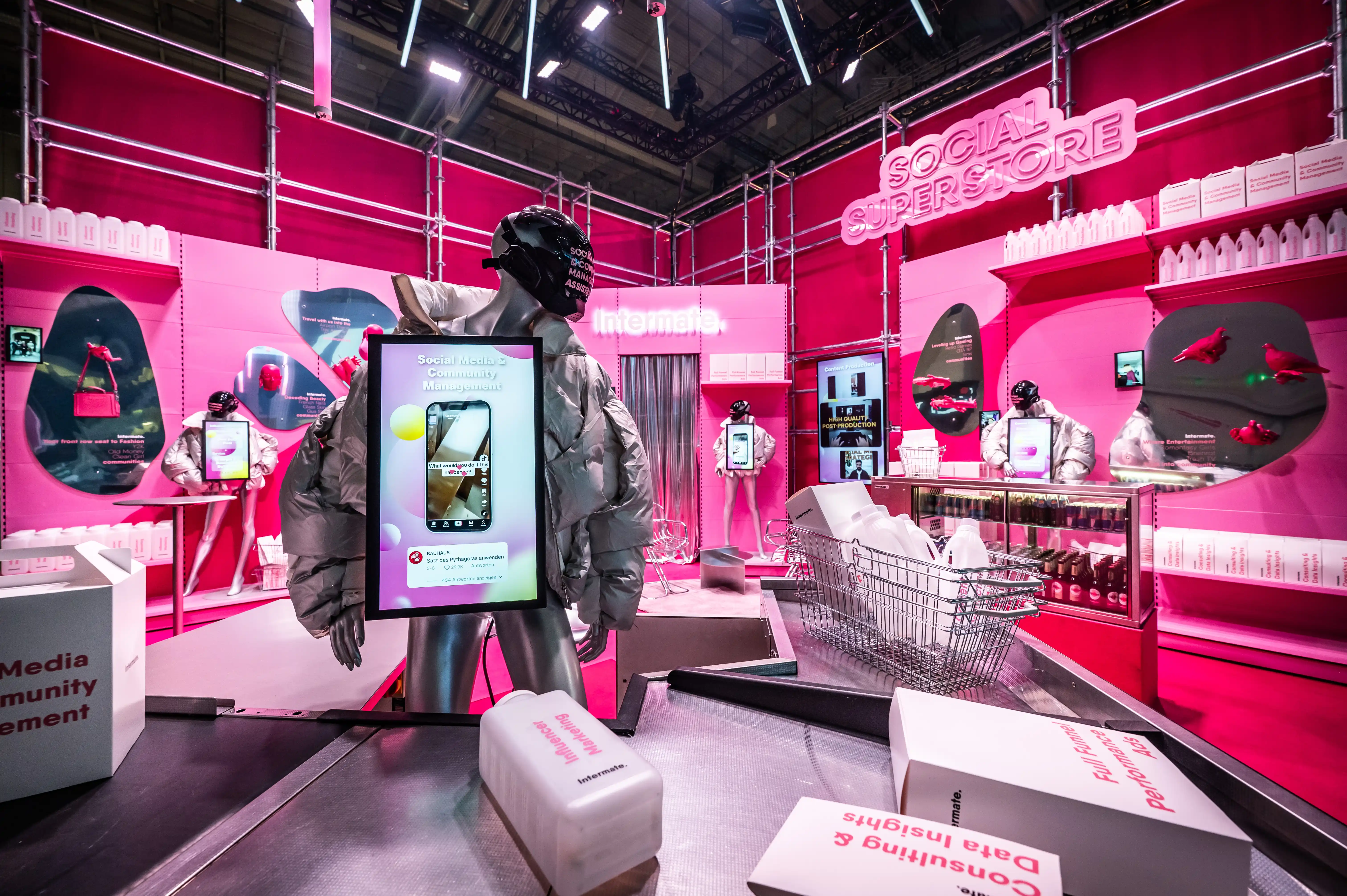 Silver mannequin with screen amid the all-pink Social Superstore scenery with shopping baskets and product shelves.