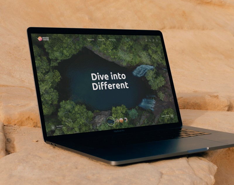A website concept design for 'NT Tourism' displayed in a laptop.