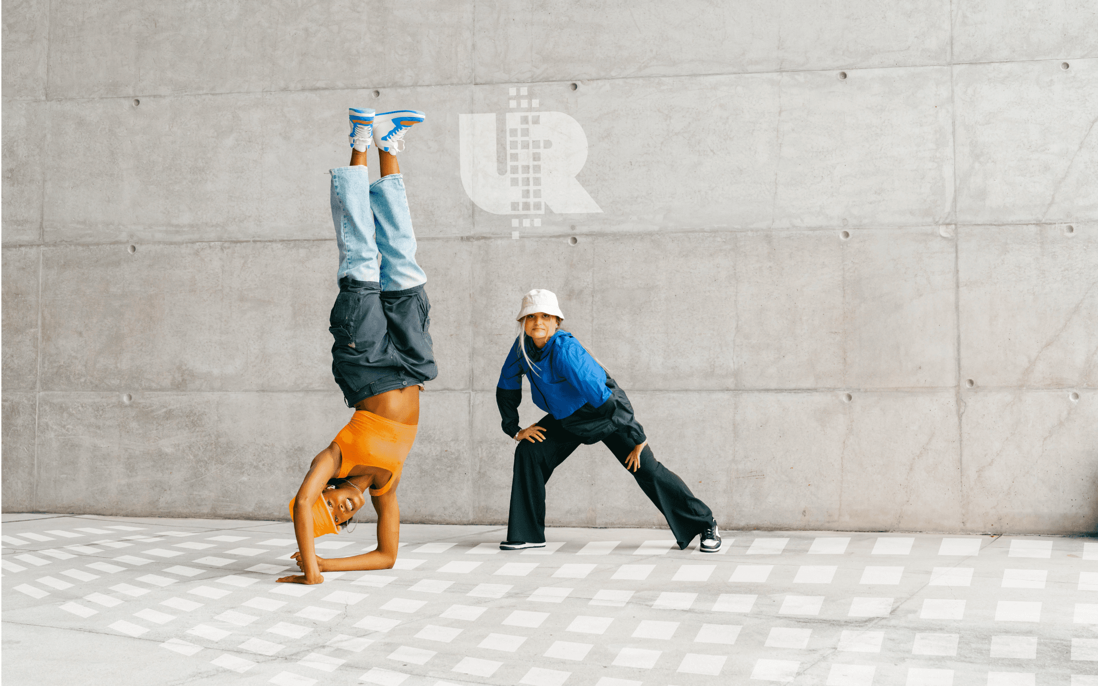 Urban dance festival logo mockup on wall with dancers in the foreground