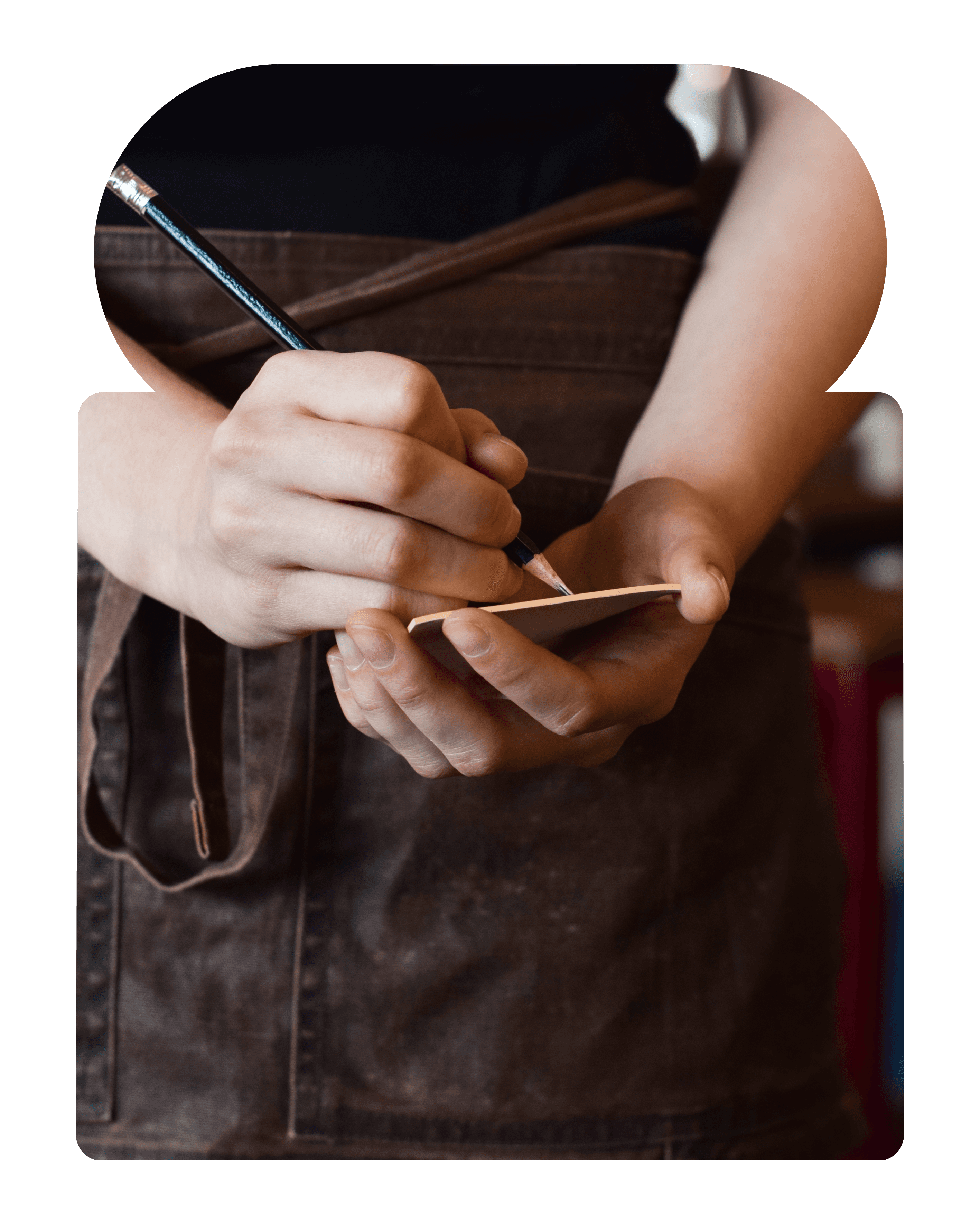Coffee served with salad, toasted bread, and a glass of juice on a small café table surrounded by indoor plants.