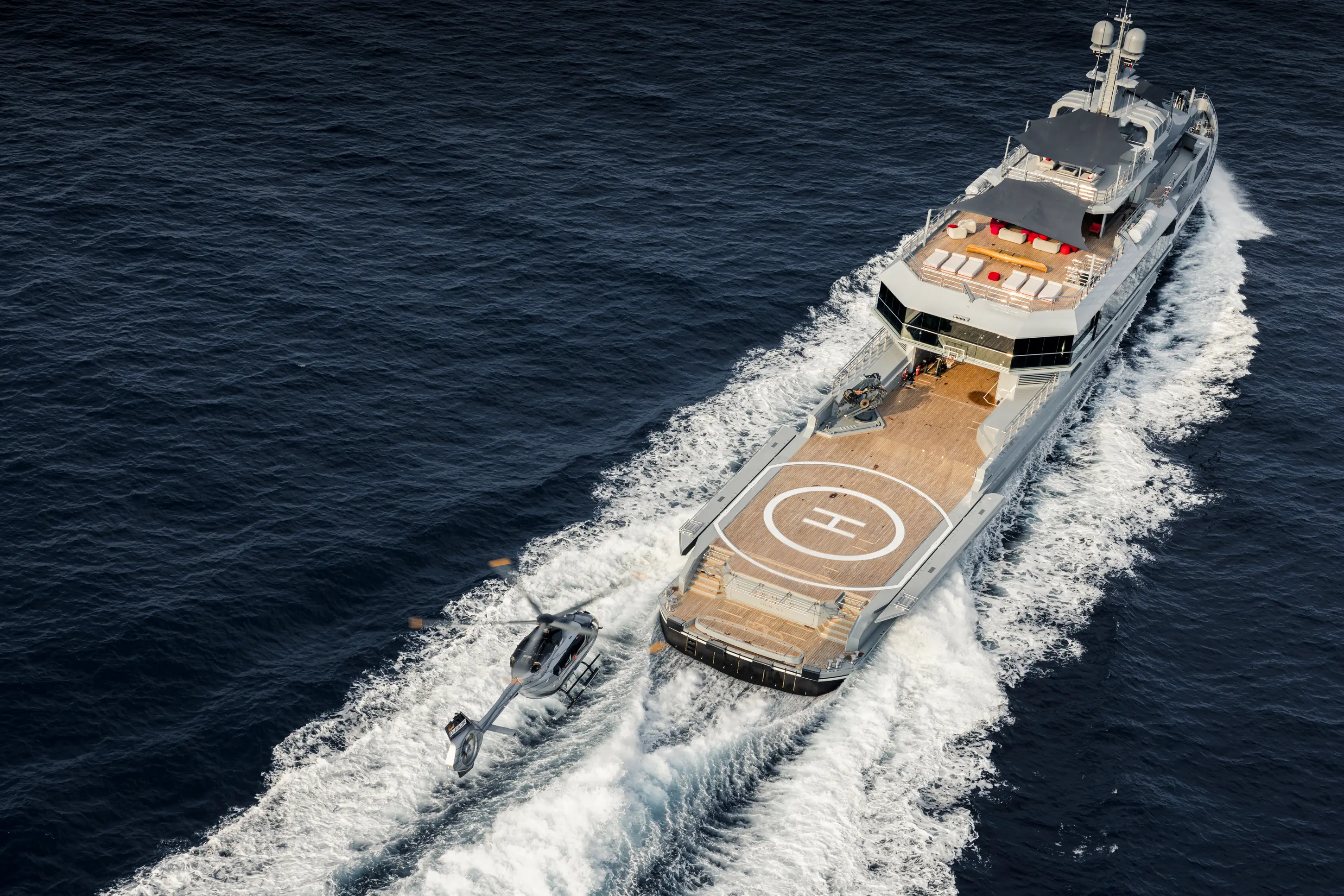 Minimalist dark interior with tiered benches and shelves.