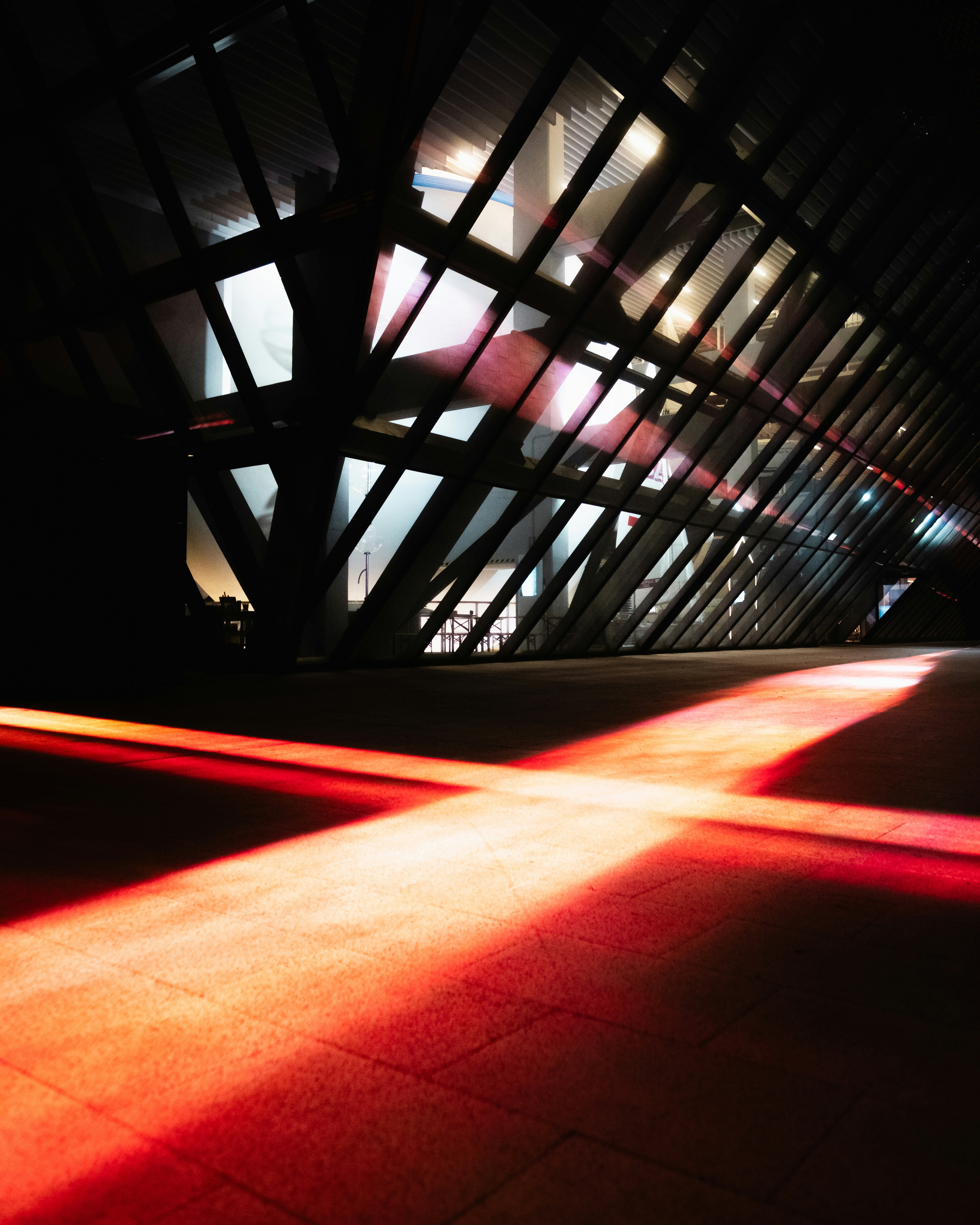 Modern architecture with red light reflections on walkway