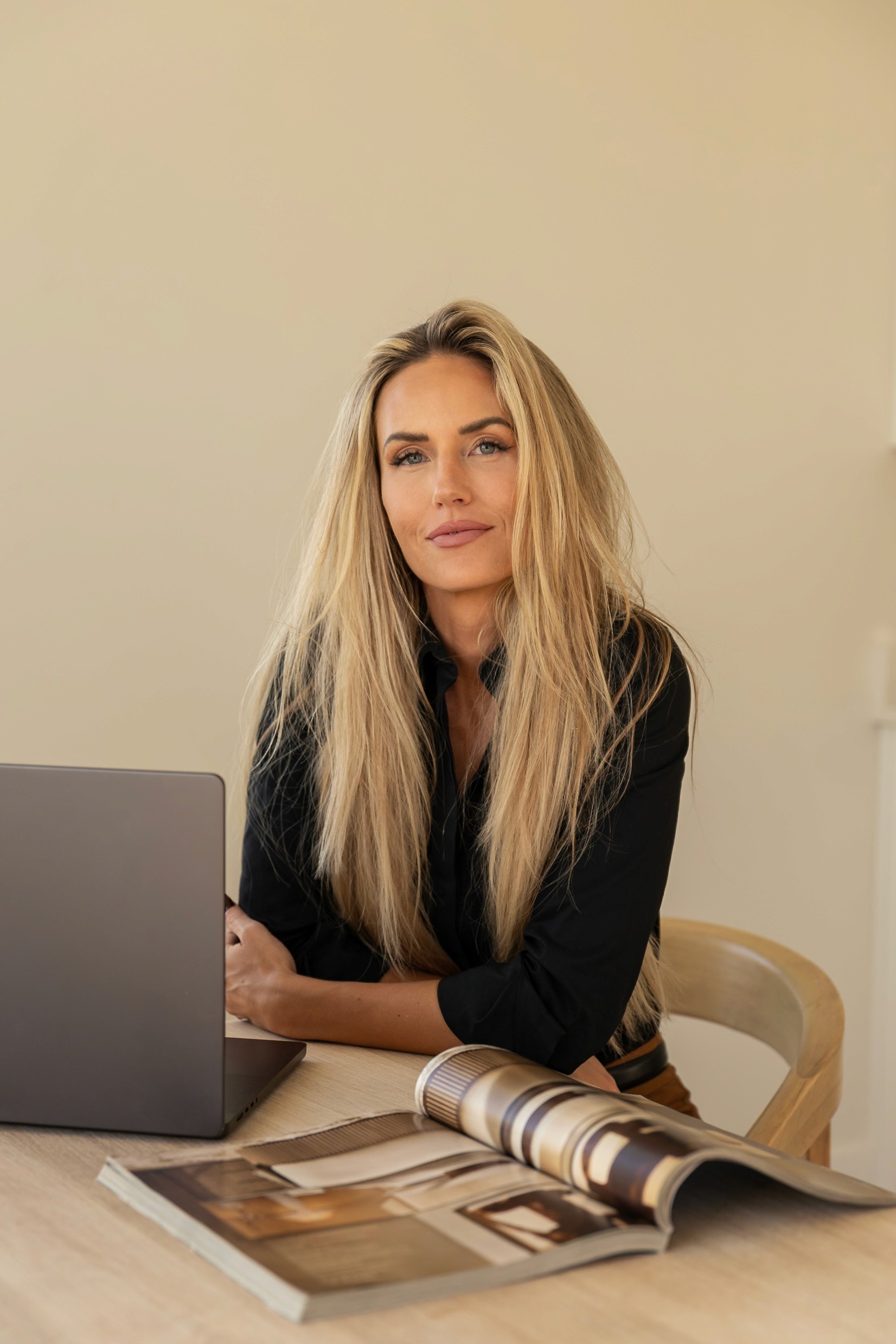 Portrait of a laughing person with curly hair wearing a white shirt