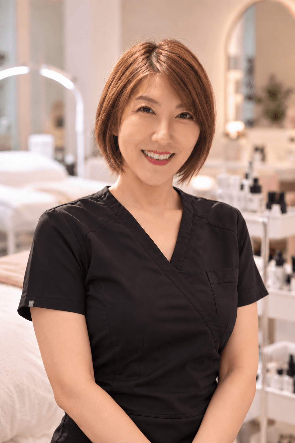 Judy, owner and lash artist at Nash's Lashes By Judy, smiling in the studio