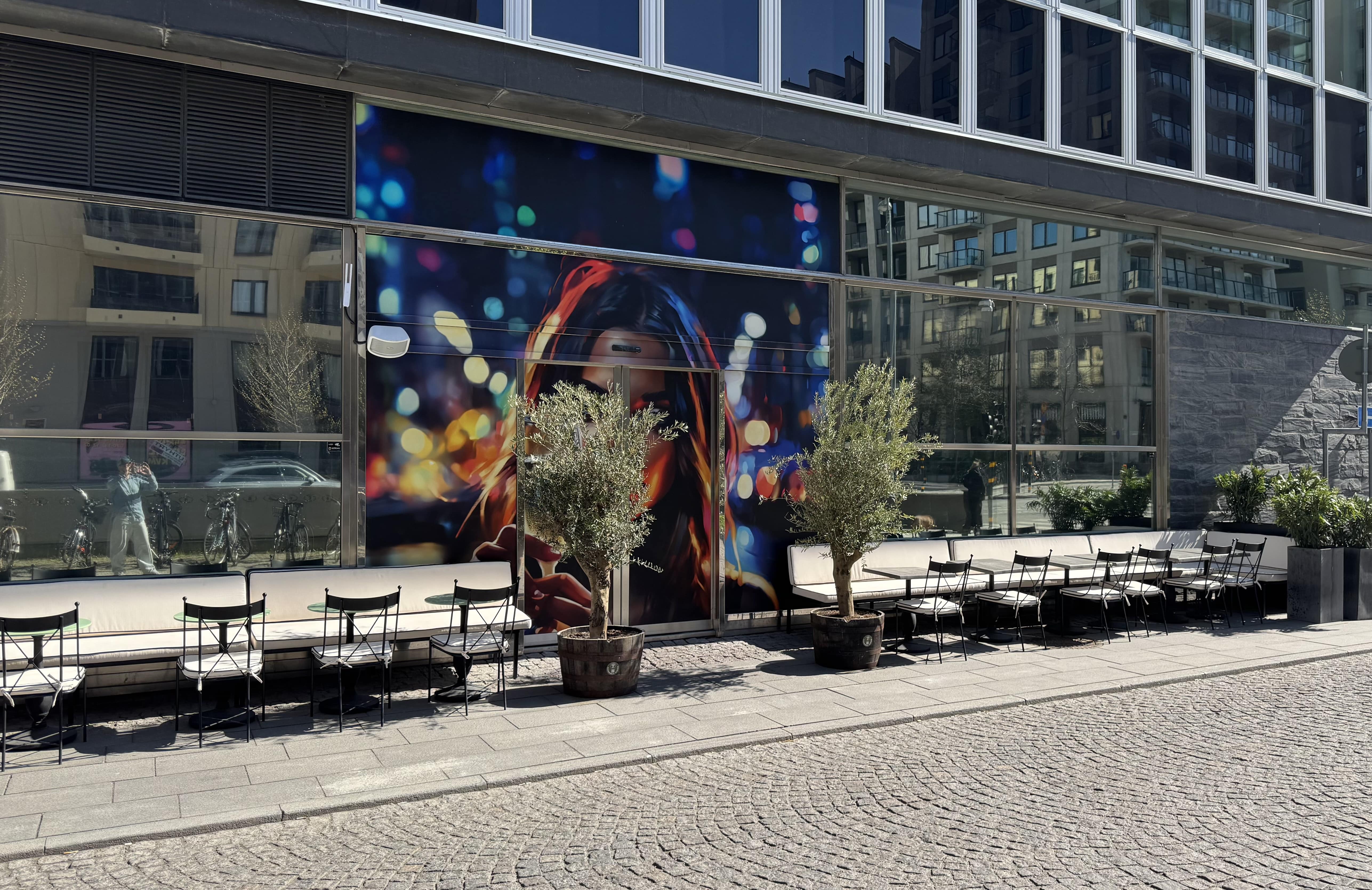 A man holding a cocktail in a dimly lit bar