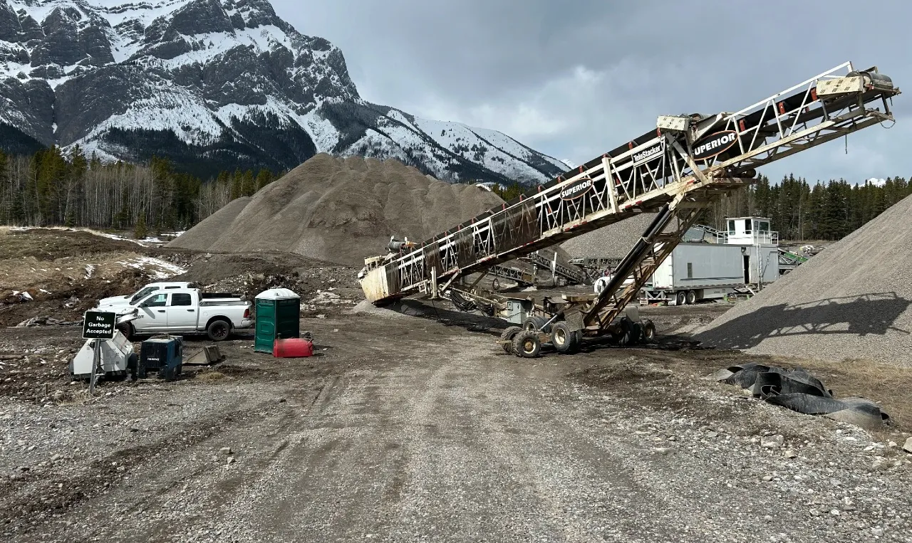 Stockpiled riprap and precast concrete culvert sections at the Evan-Thomas Storage Yard in Kananaskis, Alberta