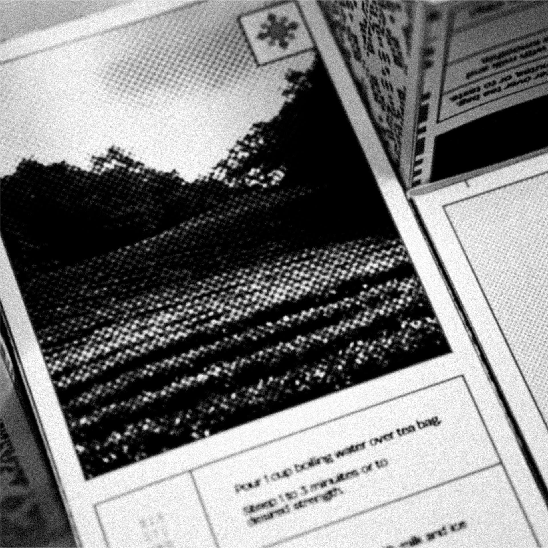 A black and white comic-style image shows a partially visible tea box with an illustration of a landscape under a large star icon, accompanied by steeping instructions focusing on boiling water and steeping time.