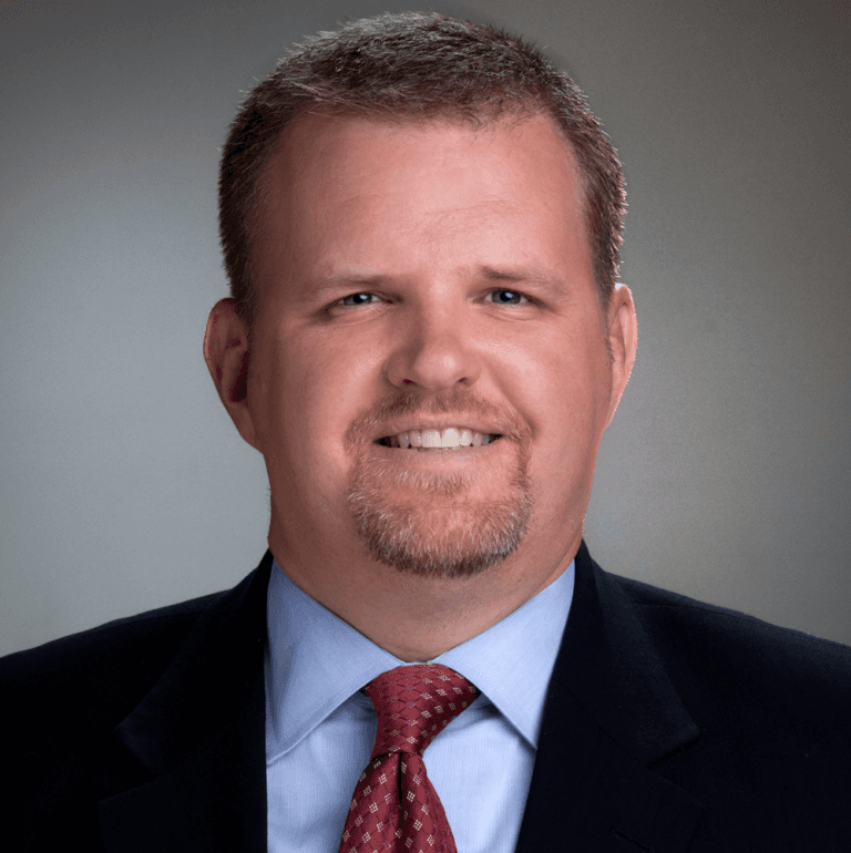 headshot of man in tie