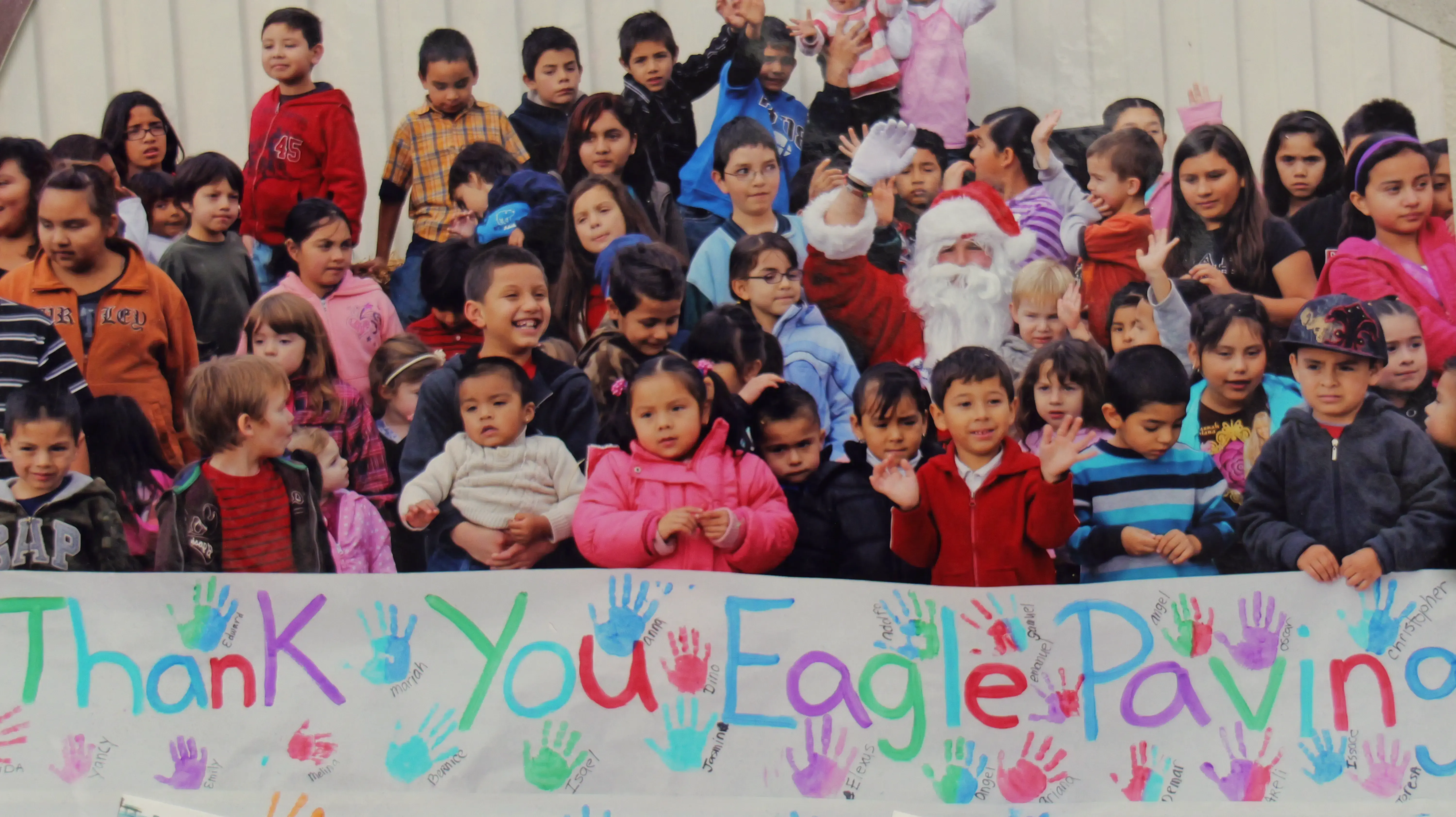 Group of kids with Thank You banner after charity event