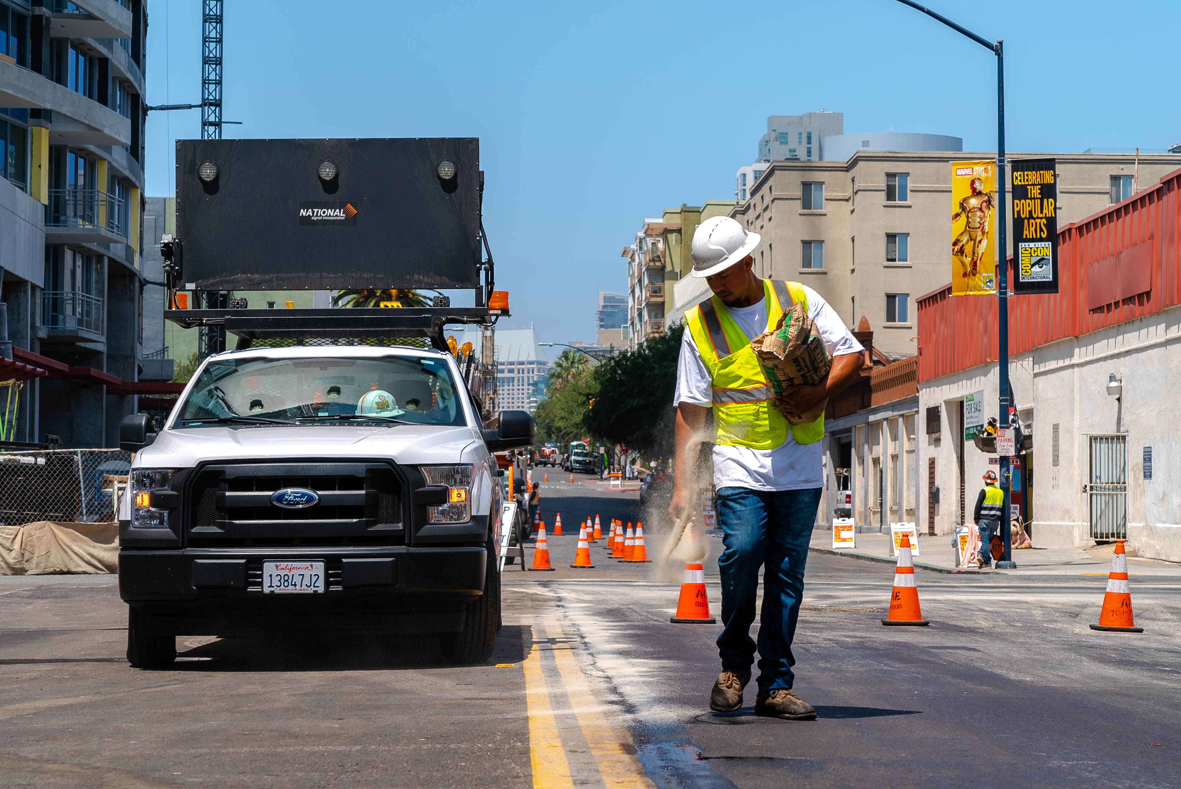 Truck and construction worker on city streets project