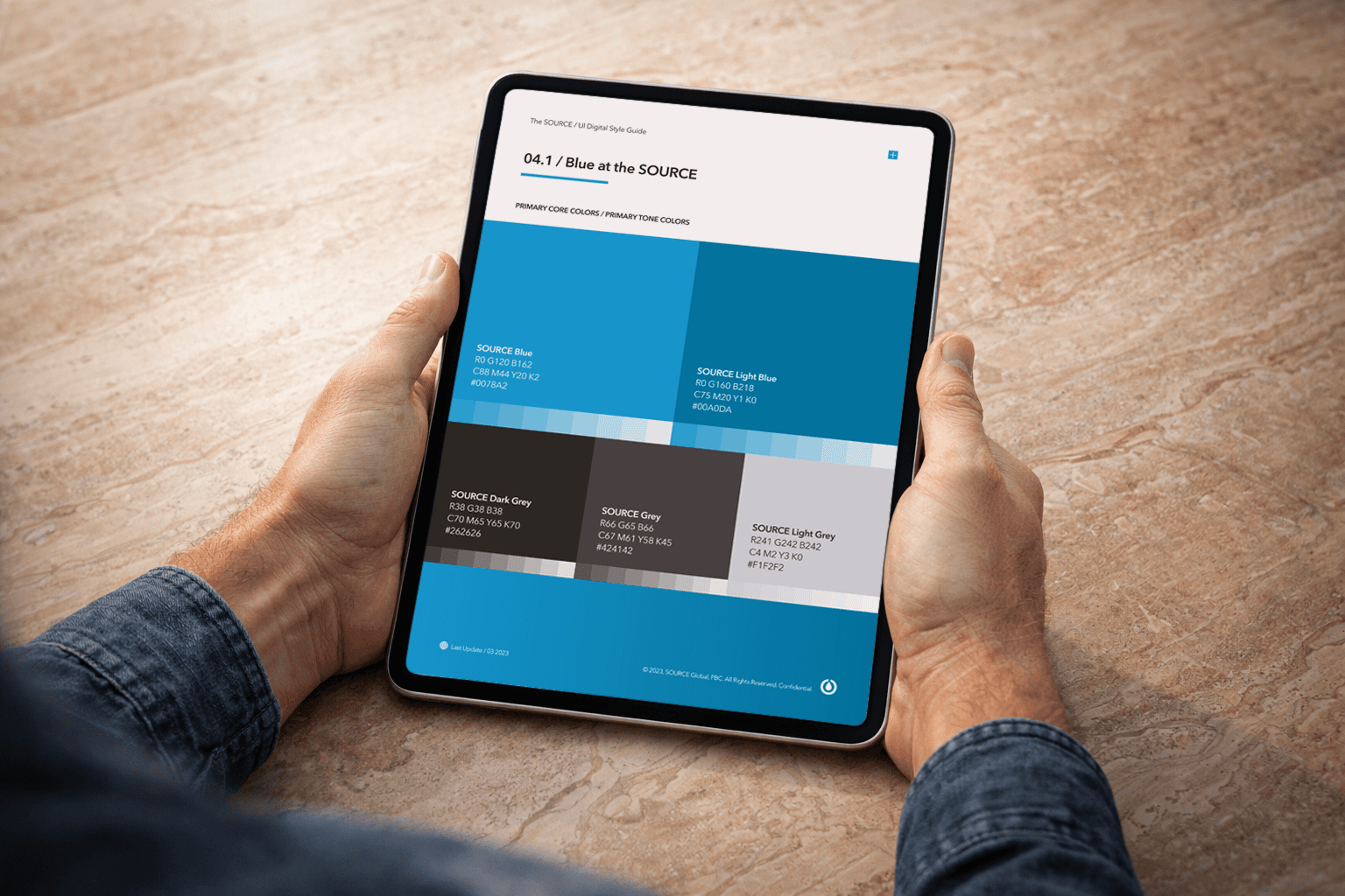 SOURCE Digital Guidelines showcasing iPad design screen on a wooden background.