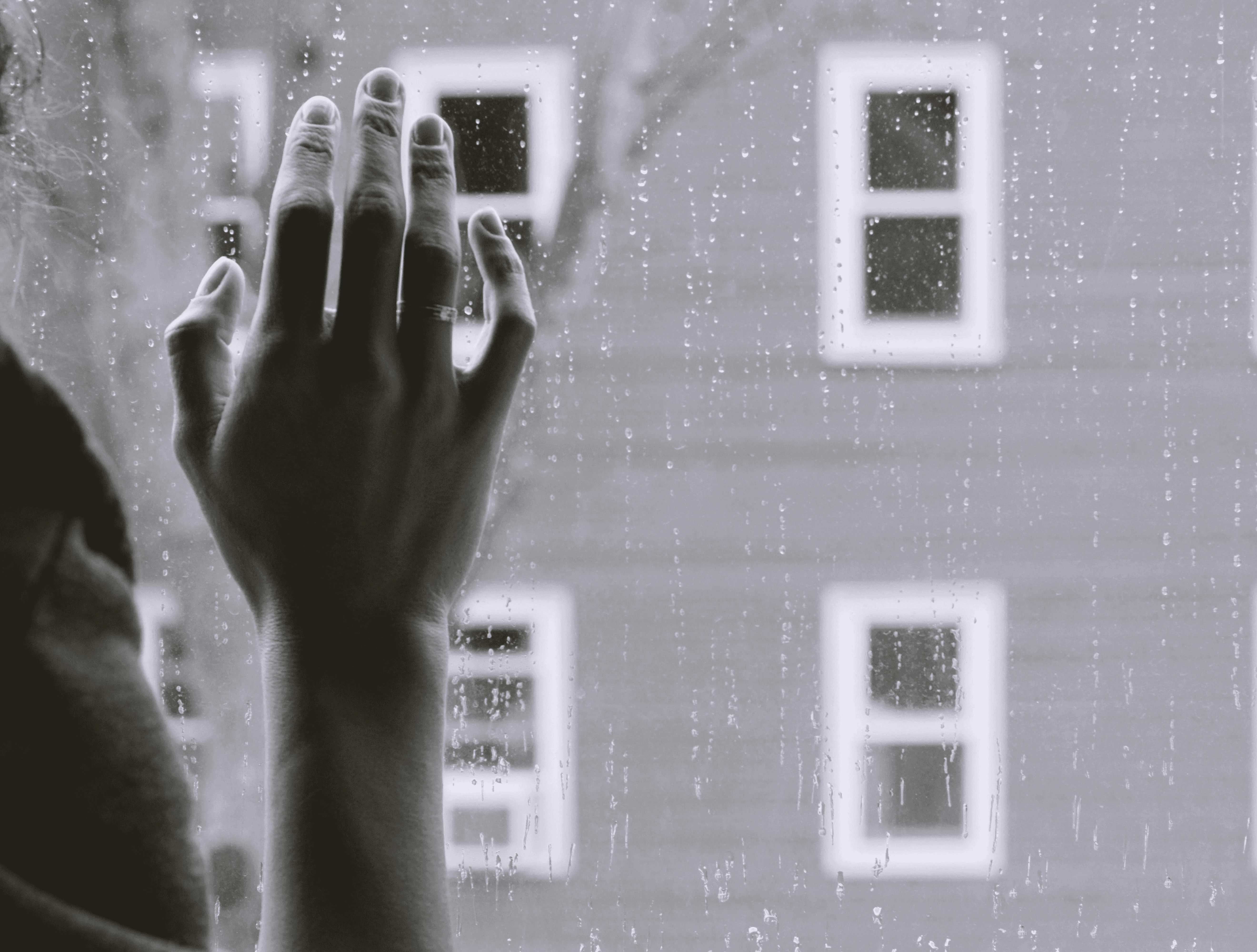 grayscale photo of woman right hand on glass