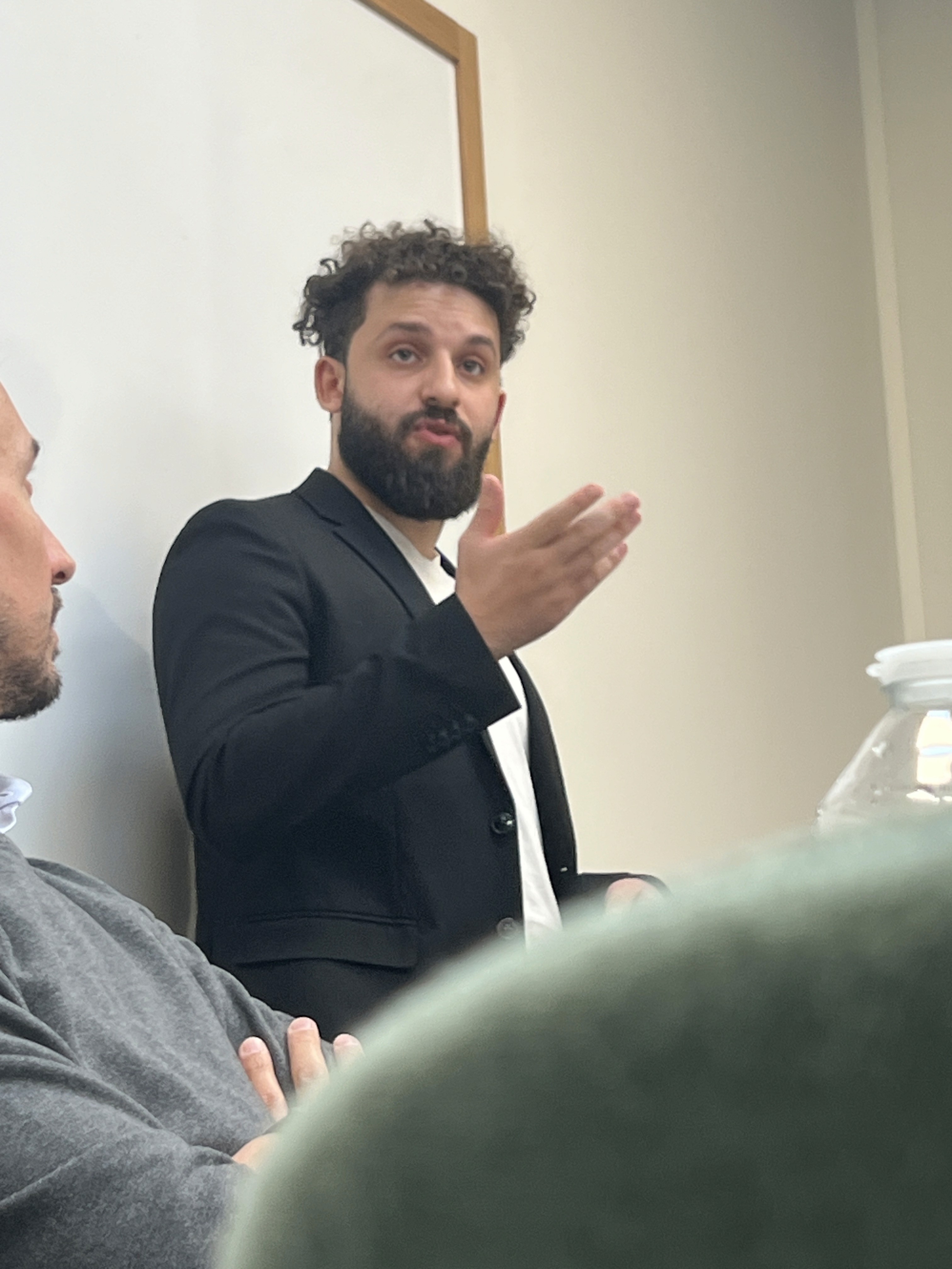 person sitting in a chair in front of a man