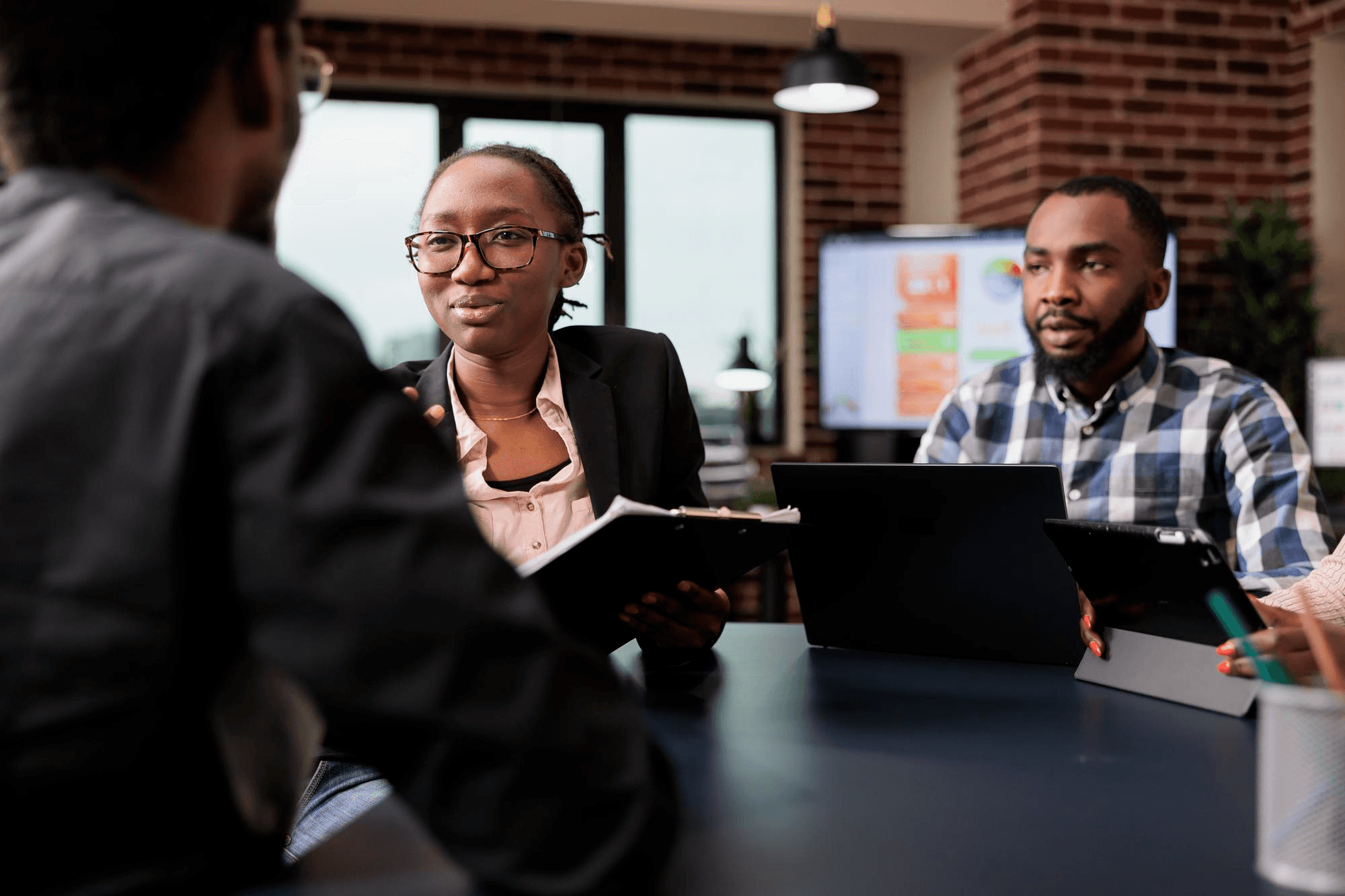 People in a kind of meeting setting while discussing