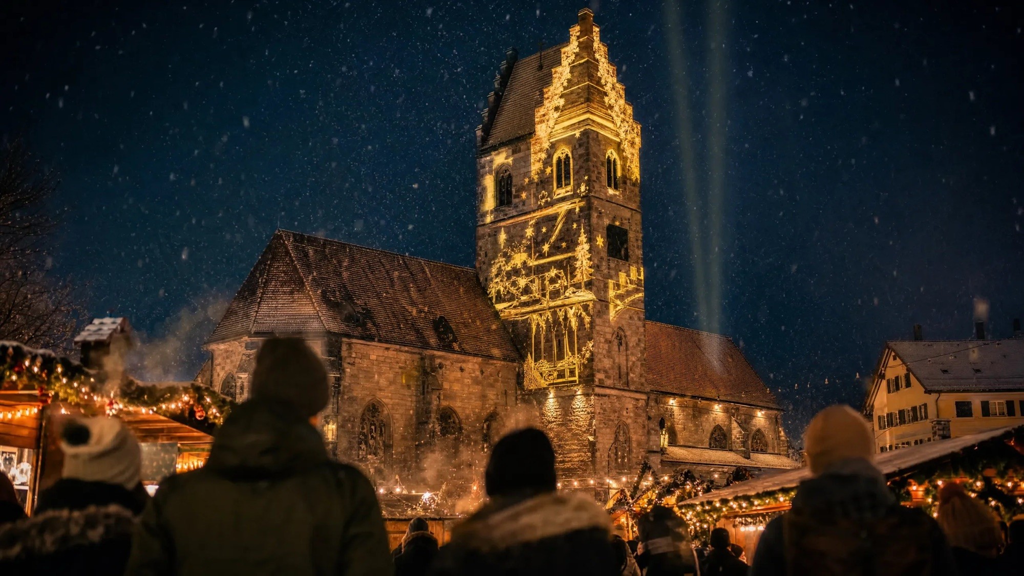 Die Margarethenkirche in Gehrden im Licht, davor der Marktplatz voller Menschen