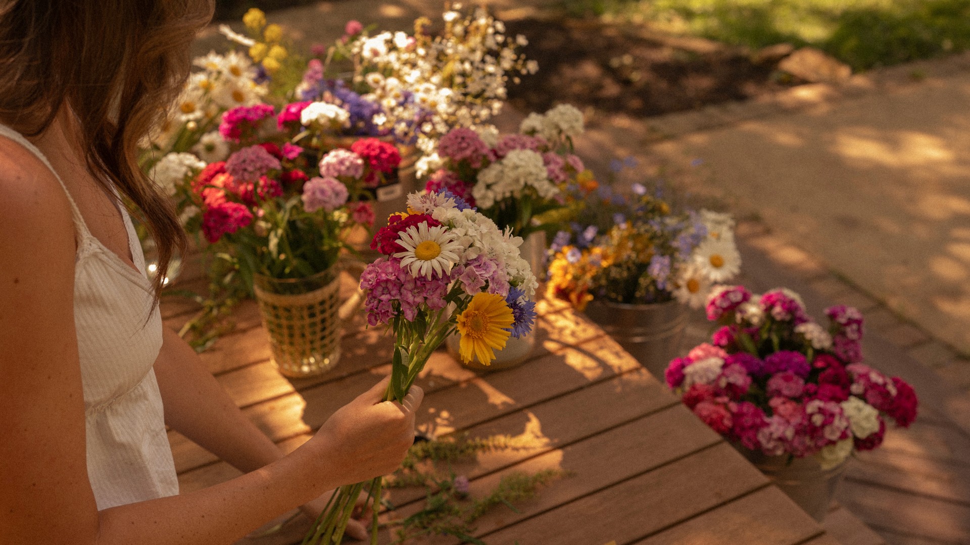 A close-up of a serene face illuminated by soft light, with shadows creating a patterned effect across the skin.