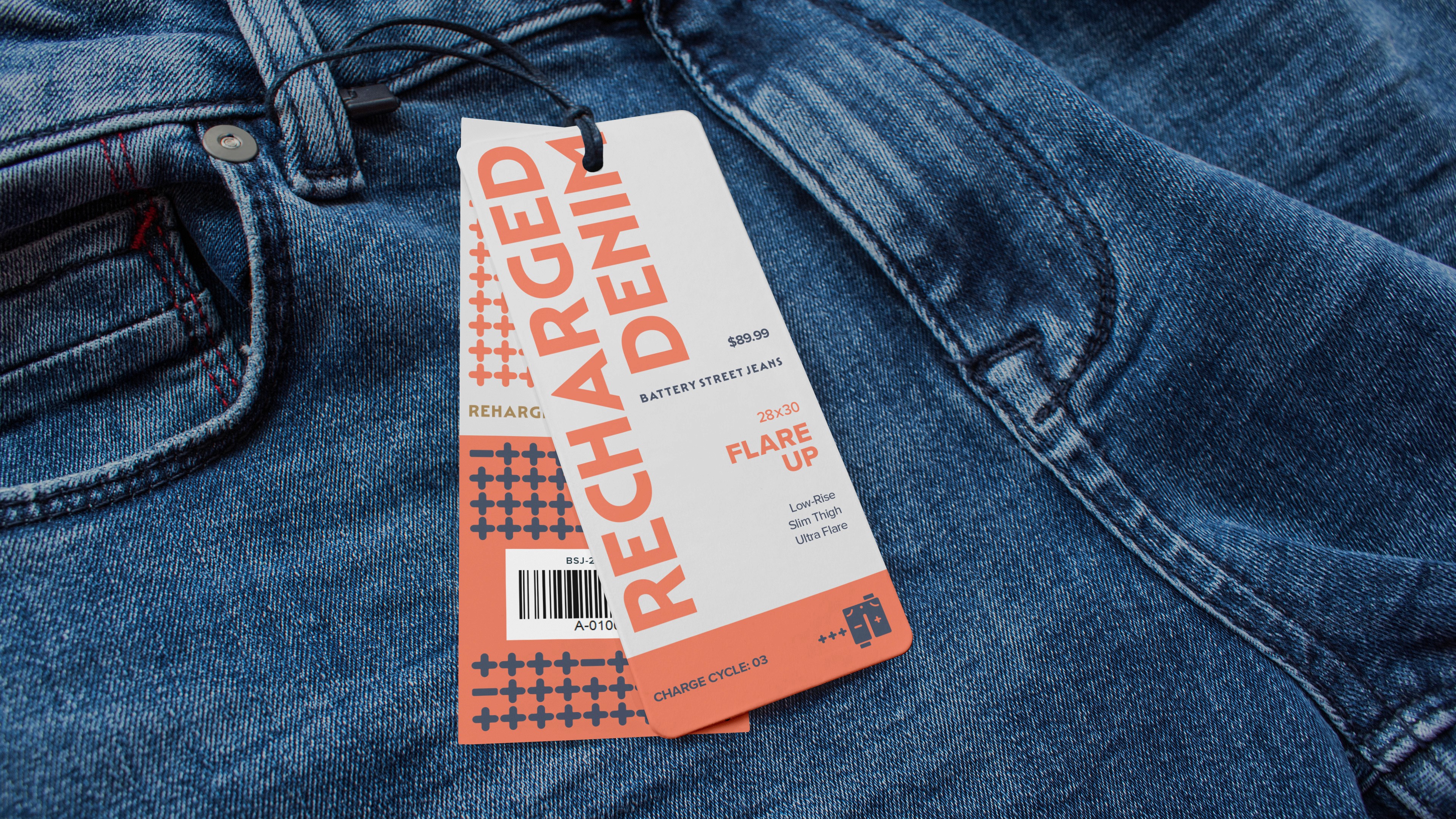 Close-up image of blue flare-up jeans with a paper tag labeled "Recharged Denim" displaying branding and price details.