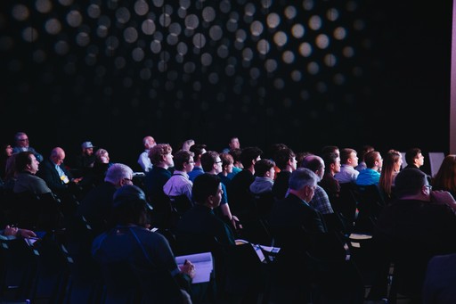 Audience at the conference listening to a talk