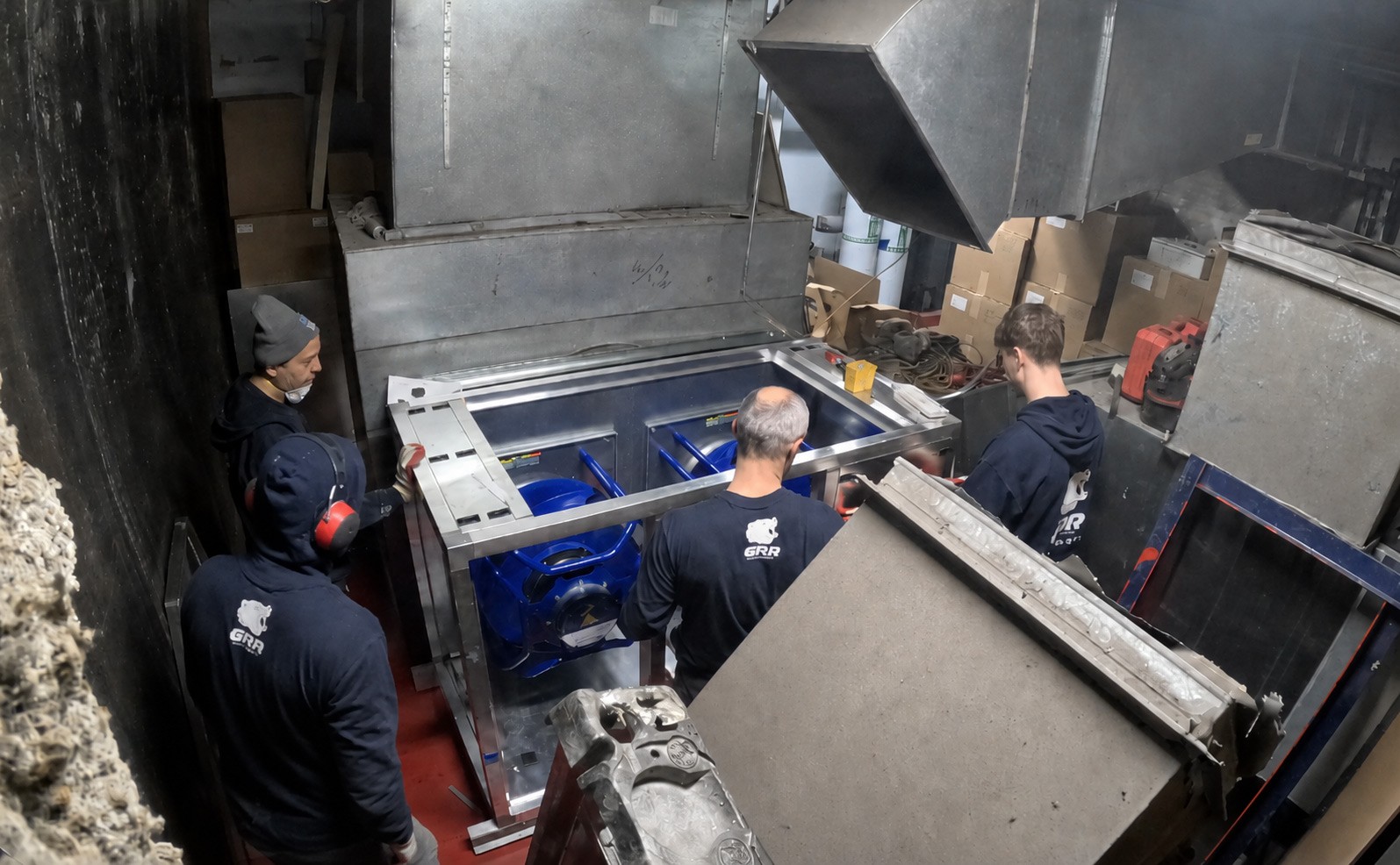 NYC hospital return fan retrofit with GRR Cooling Experts crew installing equipment inside a tight mechanical room