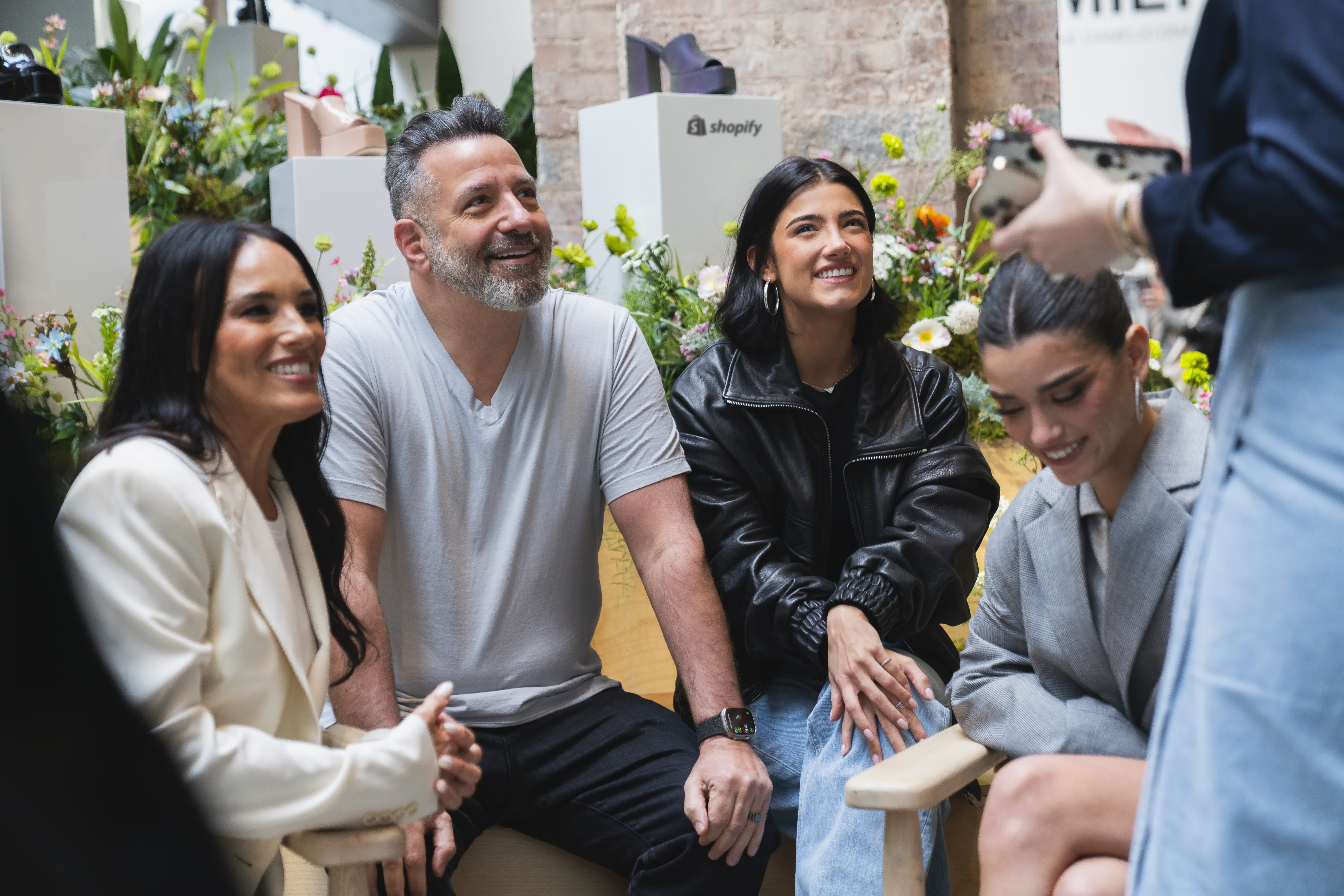 Group of creators and brand partners discussing TikTok Shop collaboration strategies in a professional networking setting.