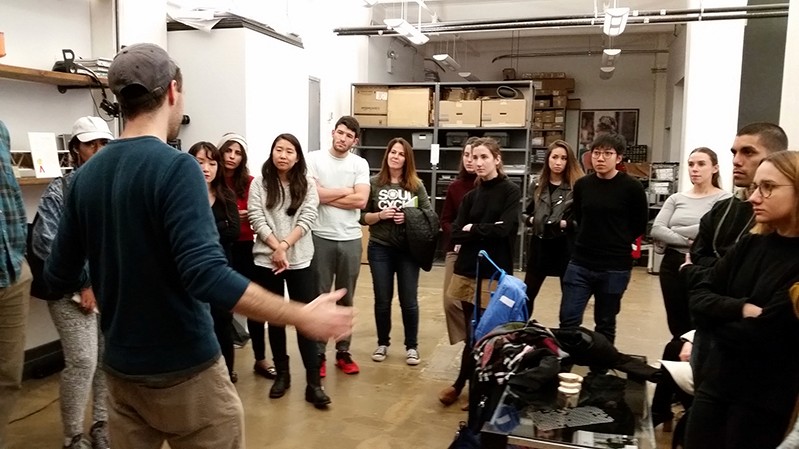 A photo of a group of students standing in an exhibition room.