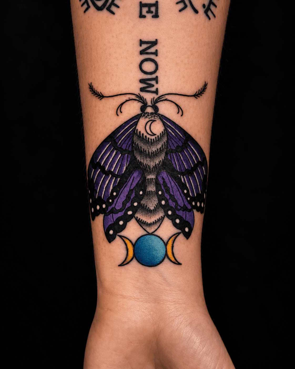 Tattoo artist working on a client’s arm in studio