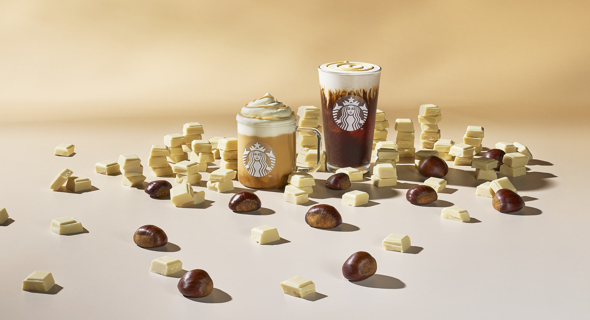 A collection of various drinks and desserts arranged artistically on a light surface, creating an inviting display.