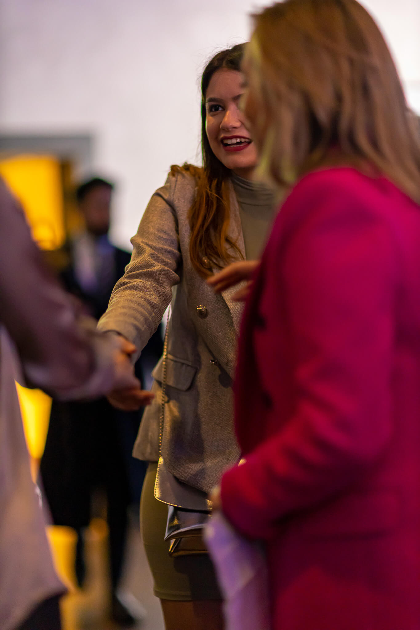 Guest greeting and chatting with attendees at a networking event