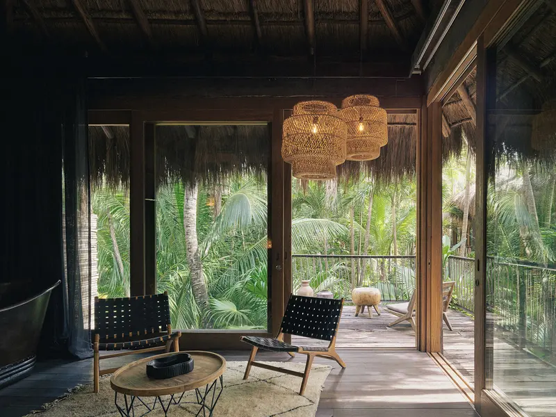 Jungle Suite at Be Tulum with seating area, carpet, and terrace providing stunning Selva views.