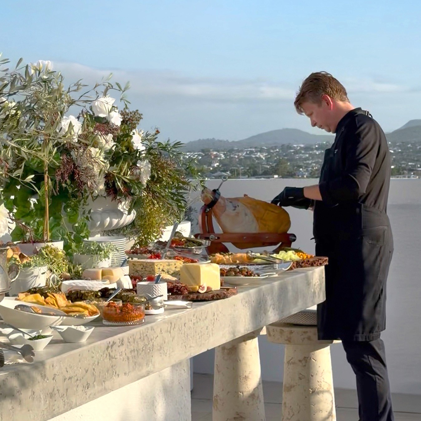 Chef craving jamon at a Mediterranean Tablescape station