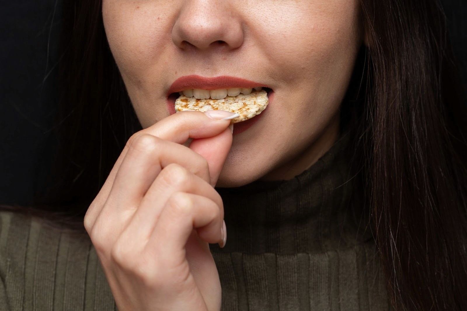 A girl taking the perfect bite into her food. 