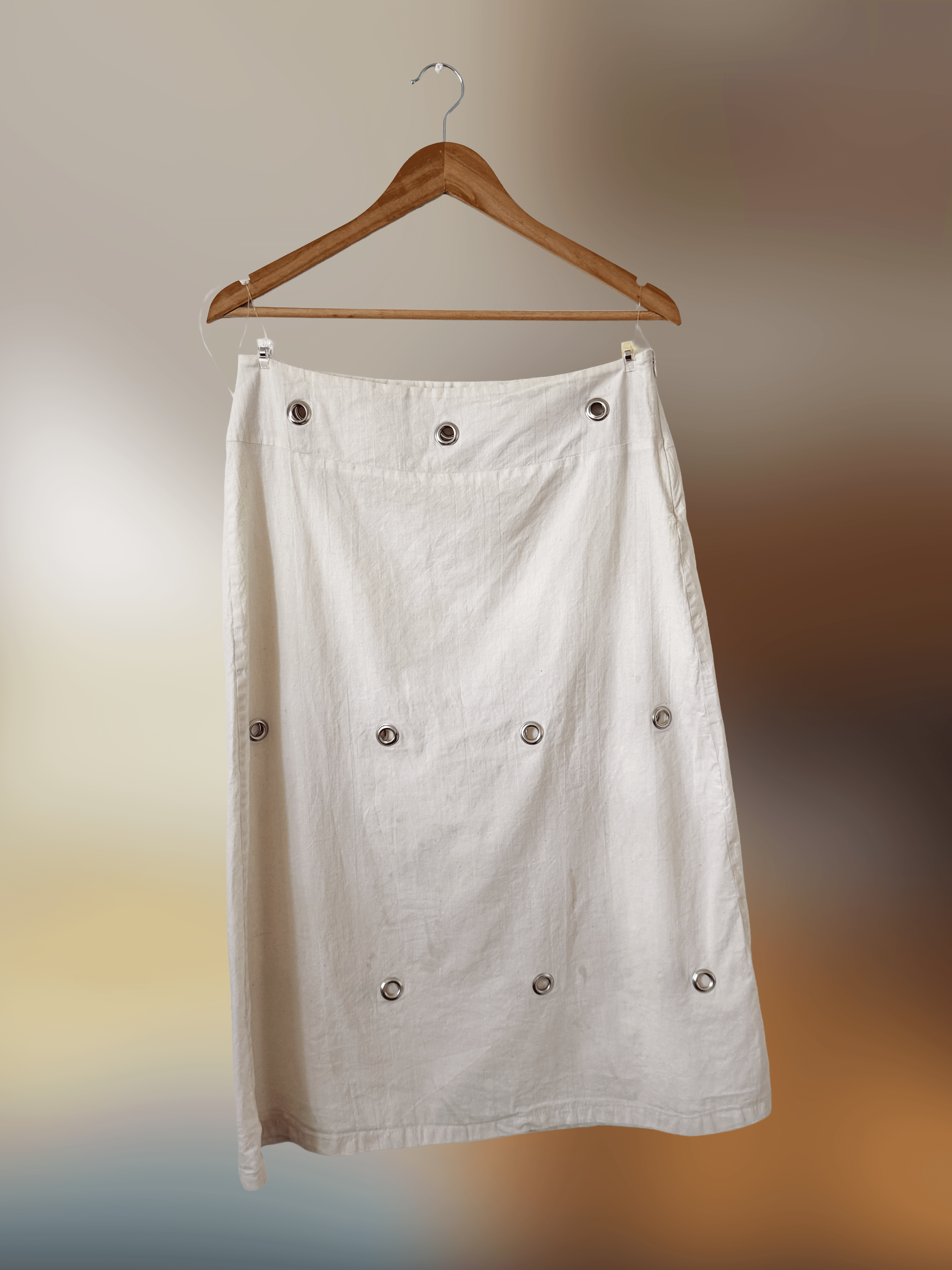 Long skirt in natural cotton with silver grommet detailing