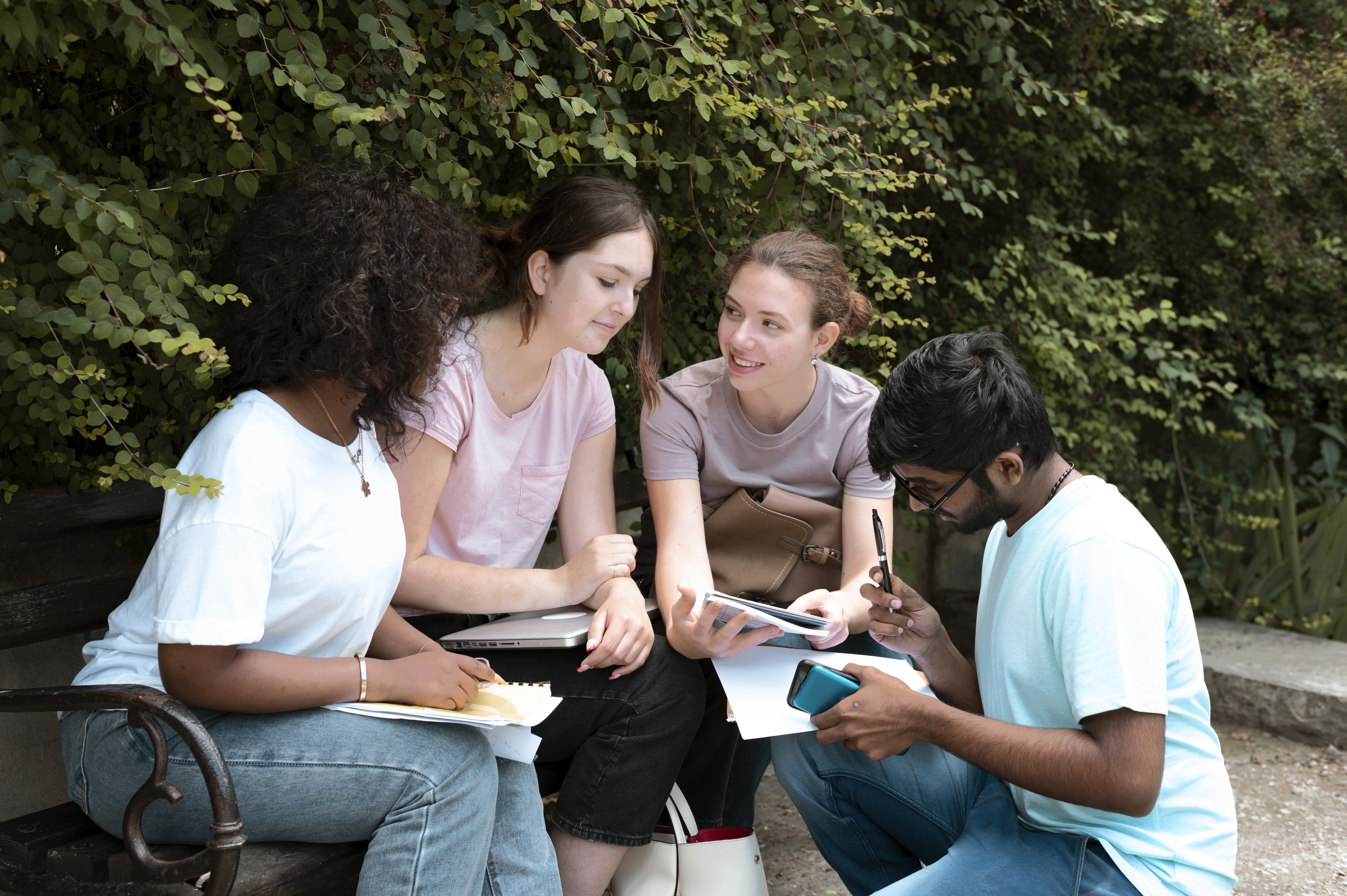 International students sitting together outdoors during a support session.