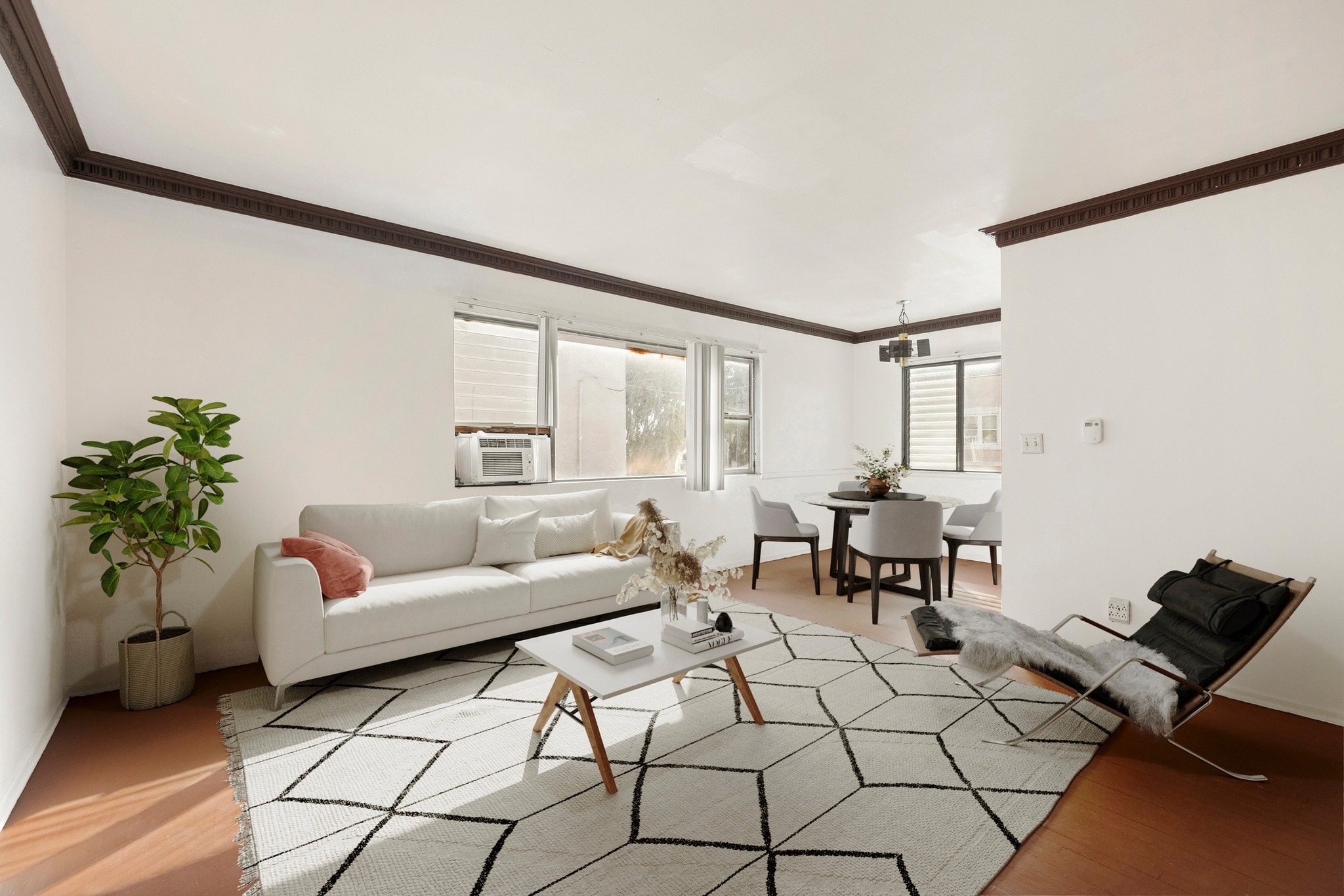 Bright living room with staged furnishings and natural light at 436 Normandie Pl.