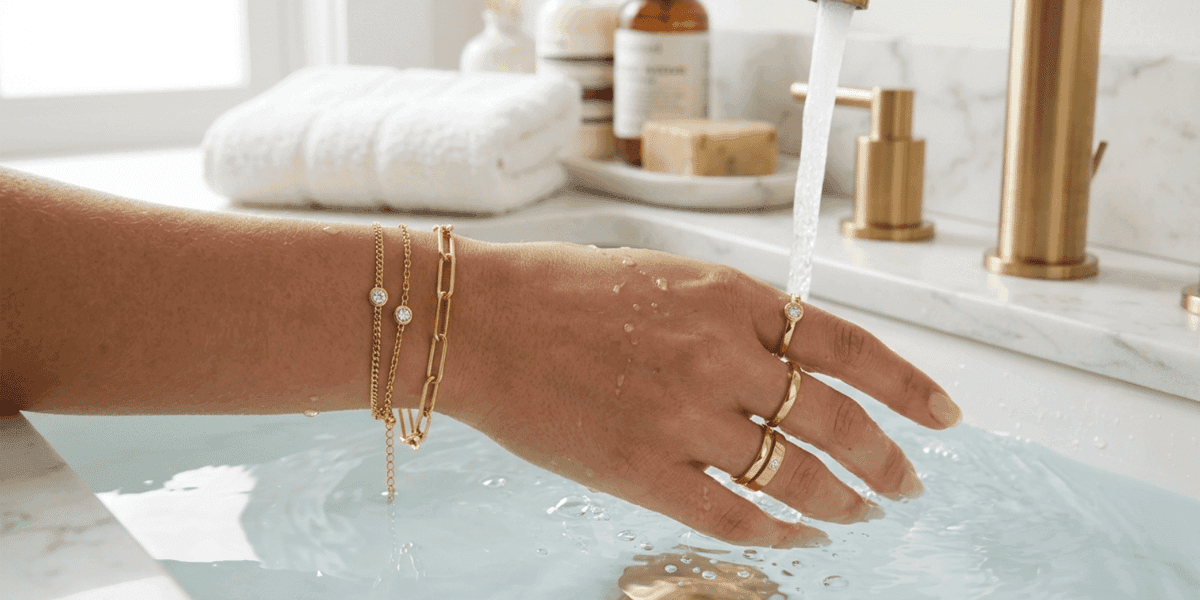 Hand wearing waterproof bracelets and rings under running water