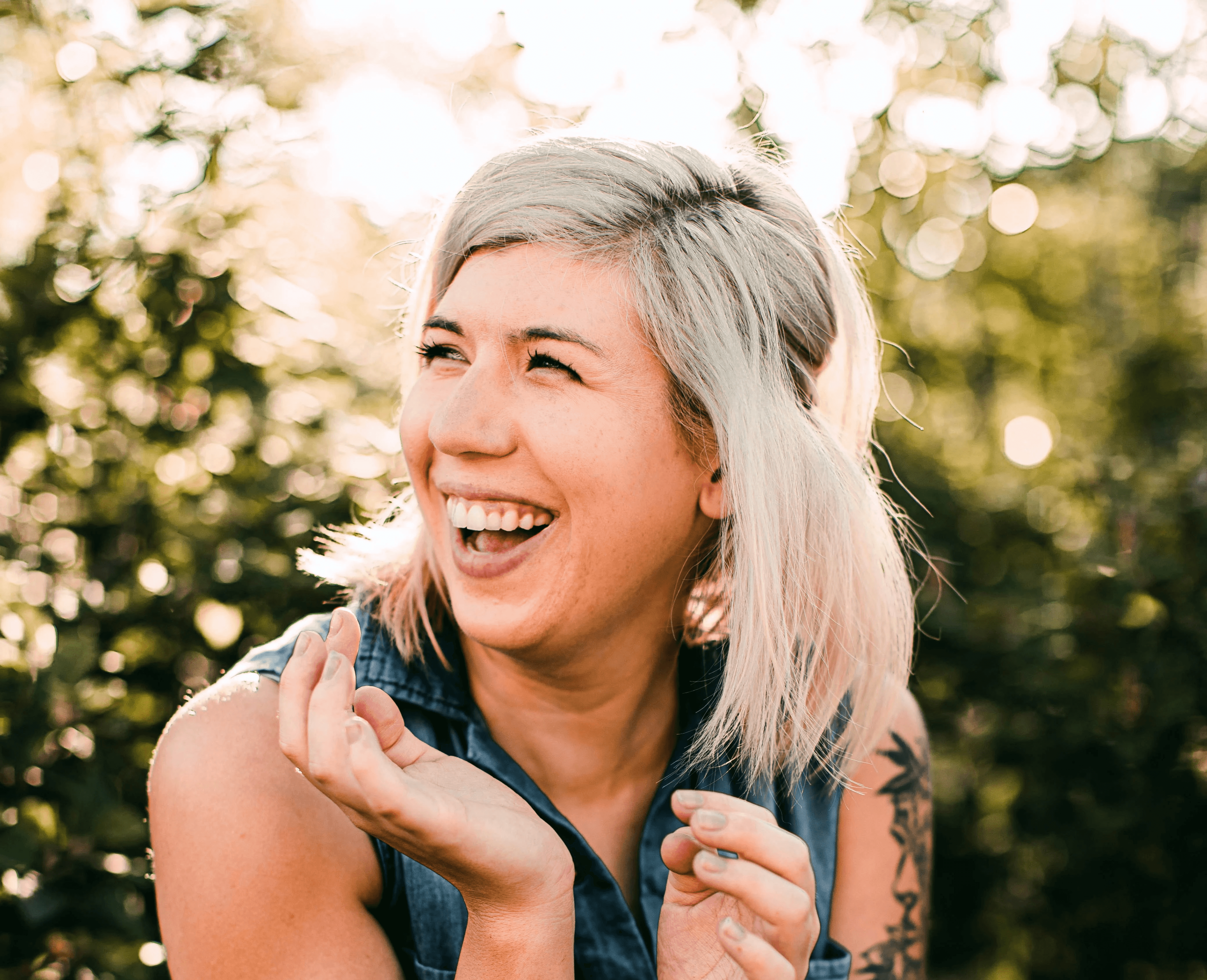 woman in black tank top smiling