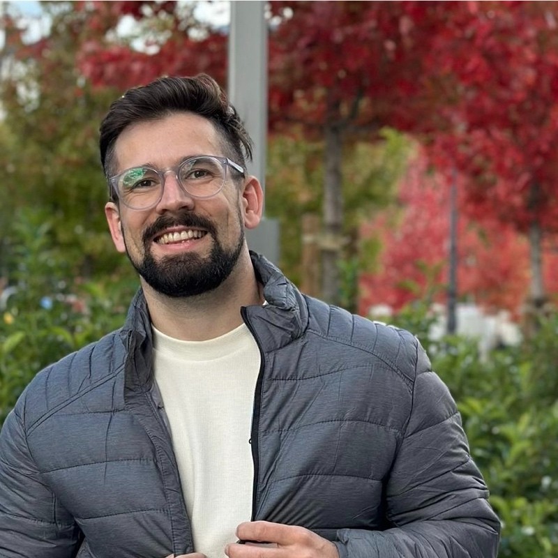 man in white dress shirt and black pants wearing black sunglasses standing on escalator