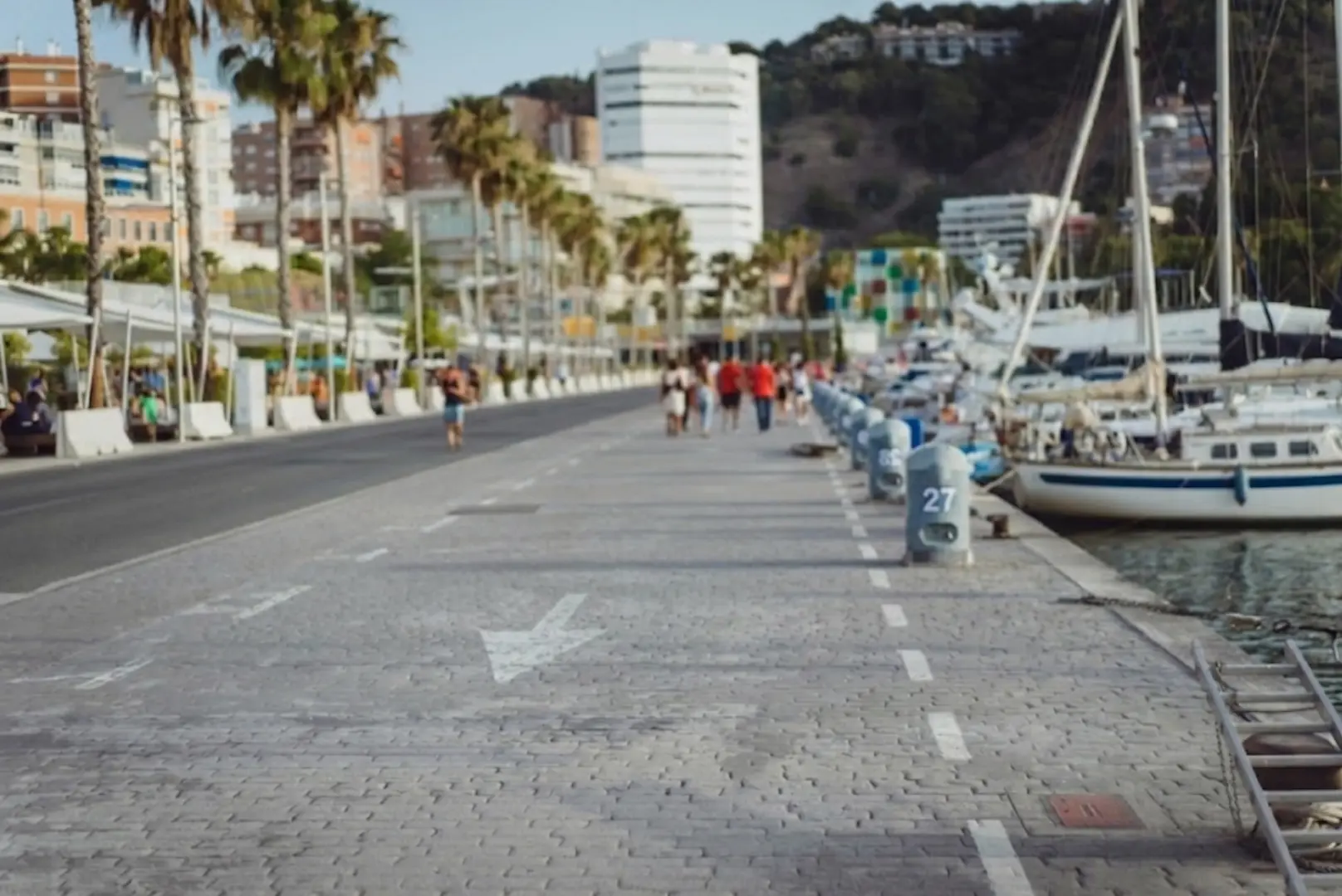 Minimalist living space with low modern furniture, large floor-to-ceiling windows, soft natural light, and an open view of a calm outdoor landscape.