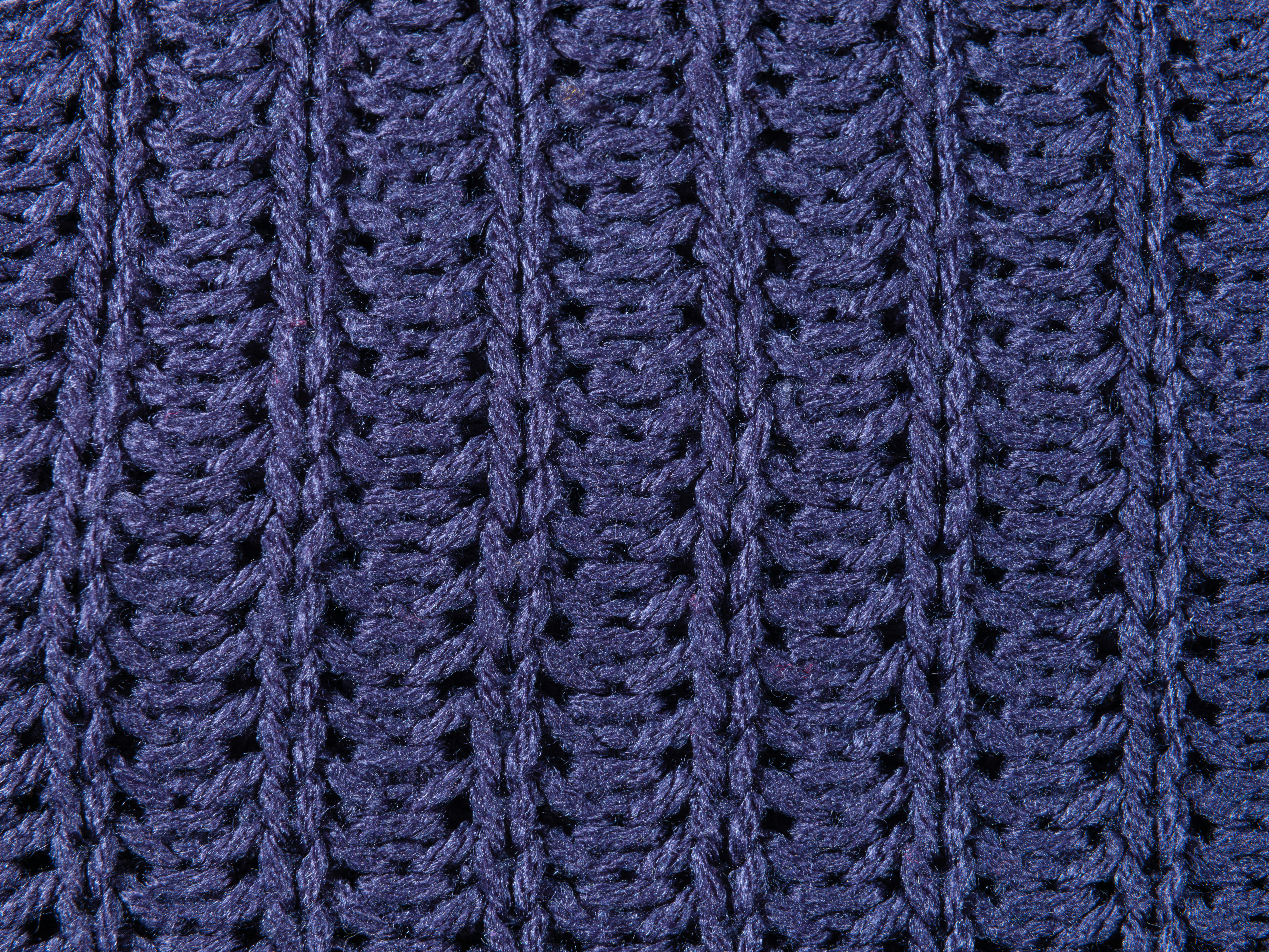 a close up of a blue knitted blanket
