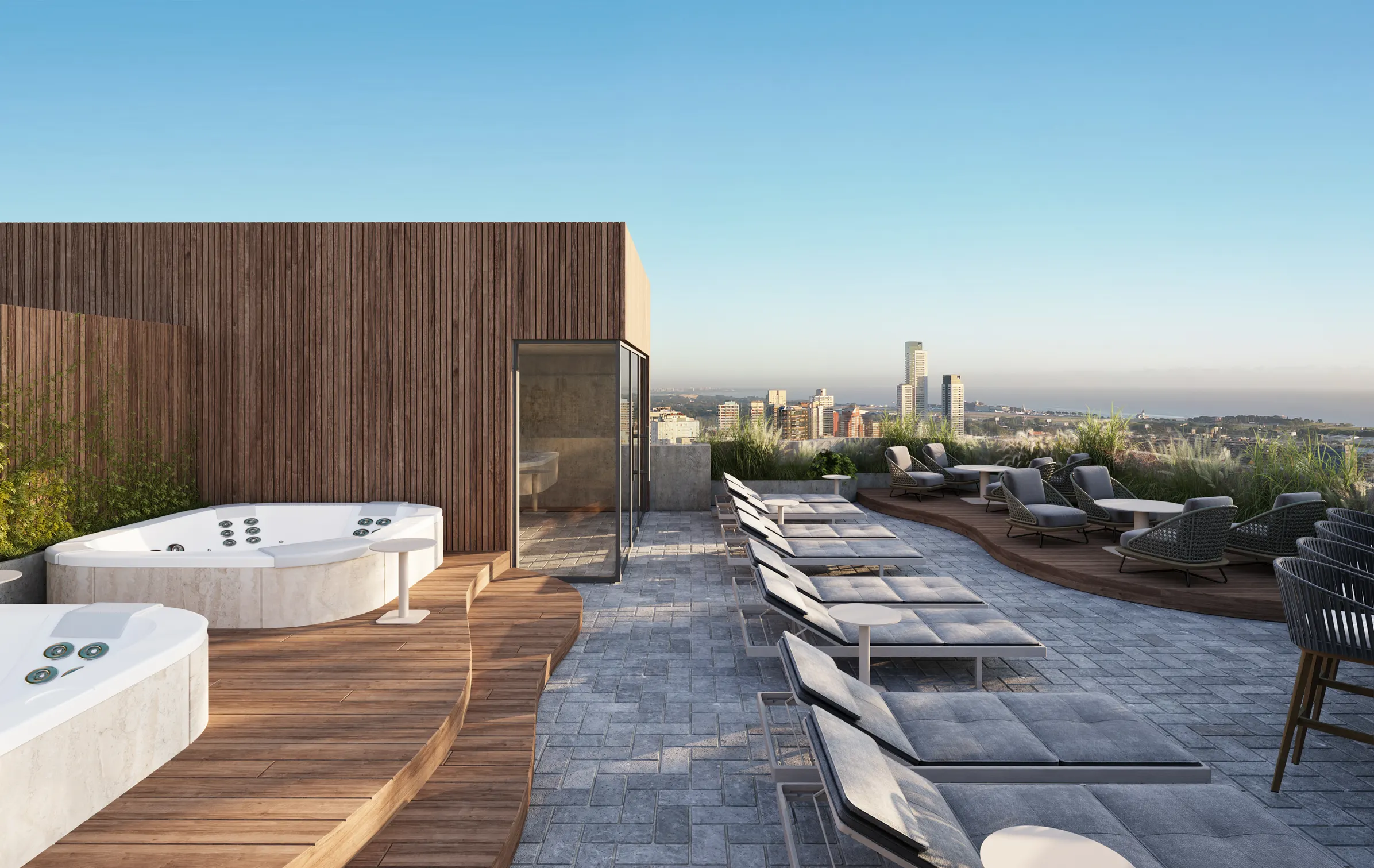 Terraza rooftop con jacuzzi, tumbonas, deck de madera y vistas panorámicas a la ciudad