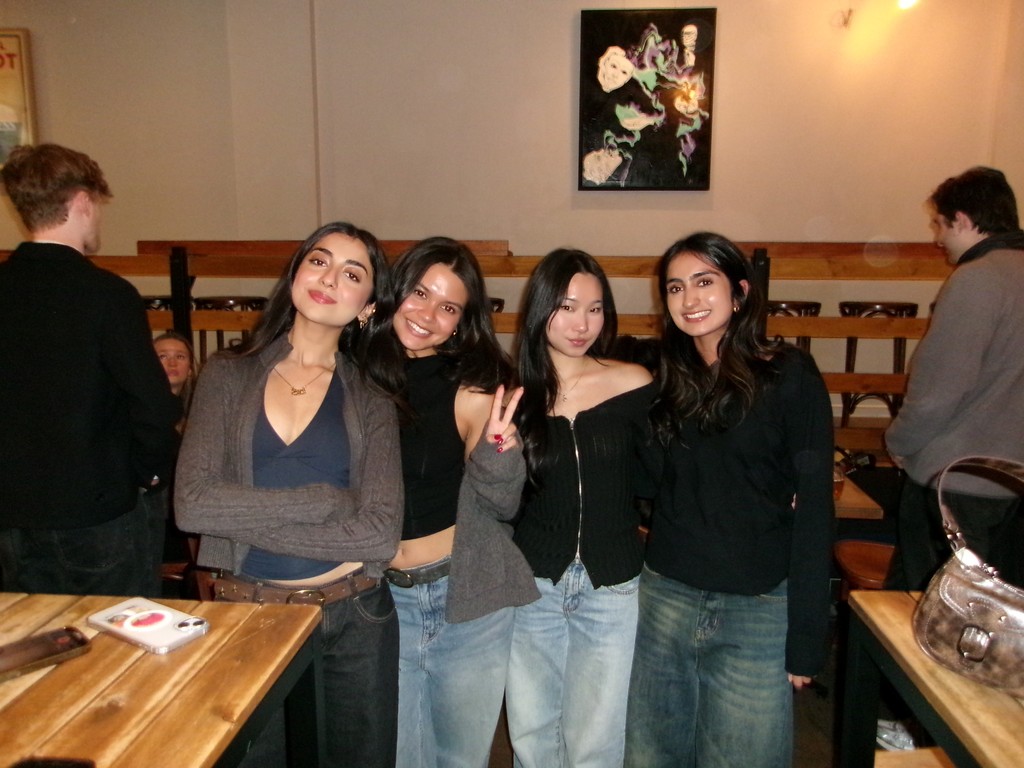 woman in gray coat singing on stage