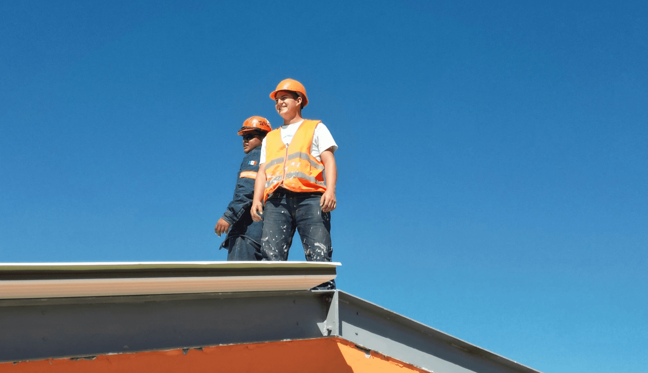 A man standing on top of a skateboard ramp
