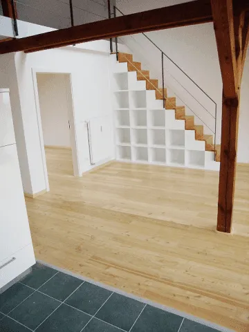 empty room with wooden floor and stairs