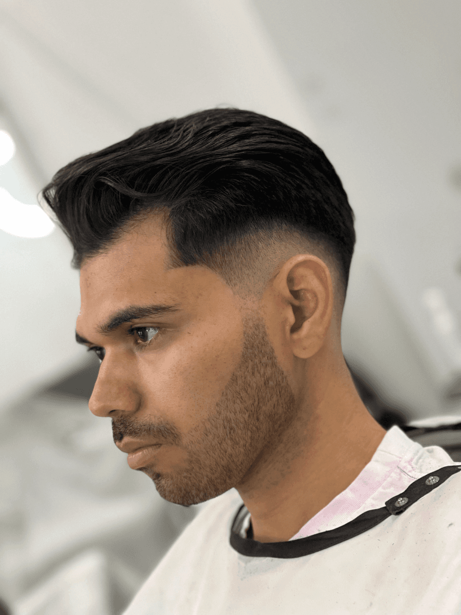 shallow focus photo of man holding scissors