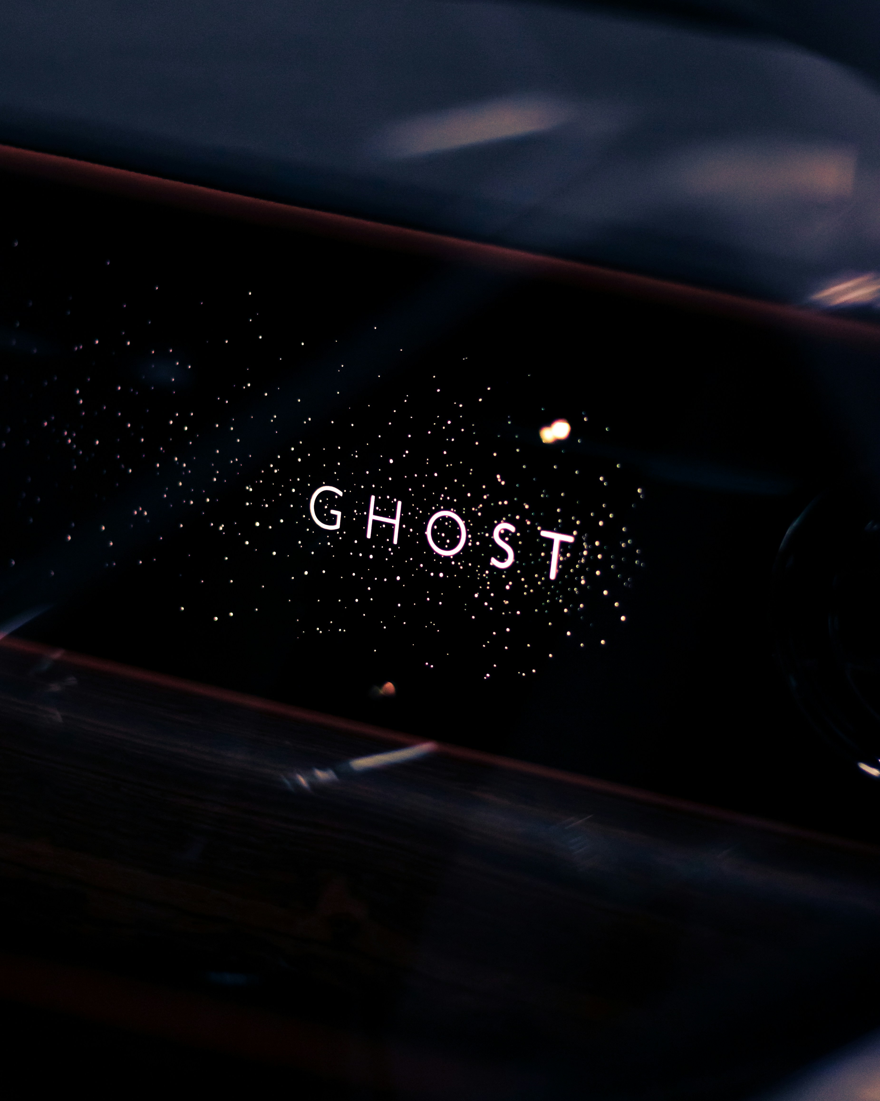 a close up of a car dashboard with the word ghost written on it