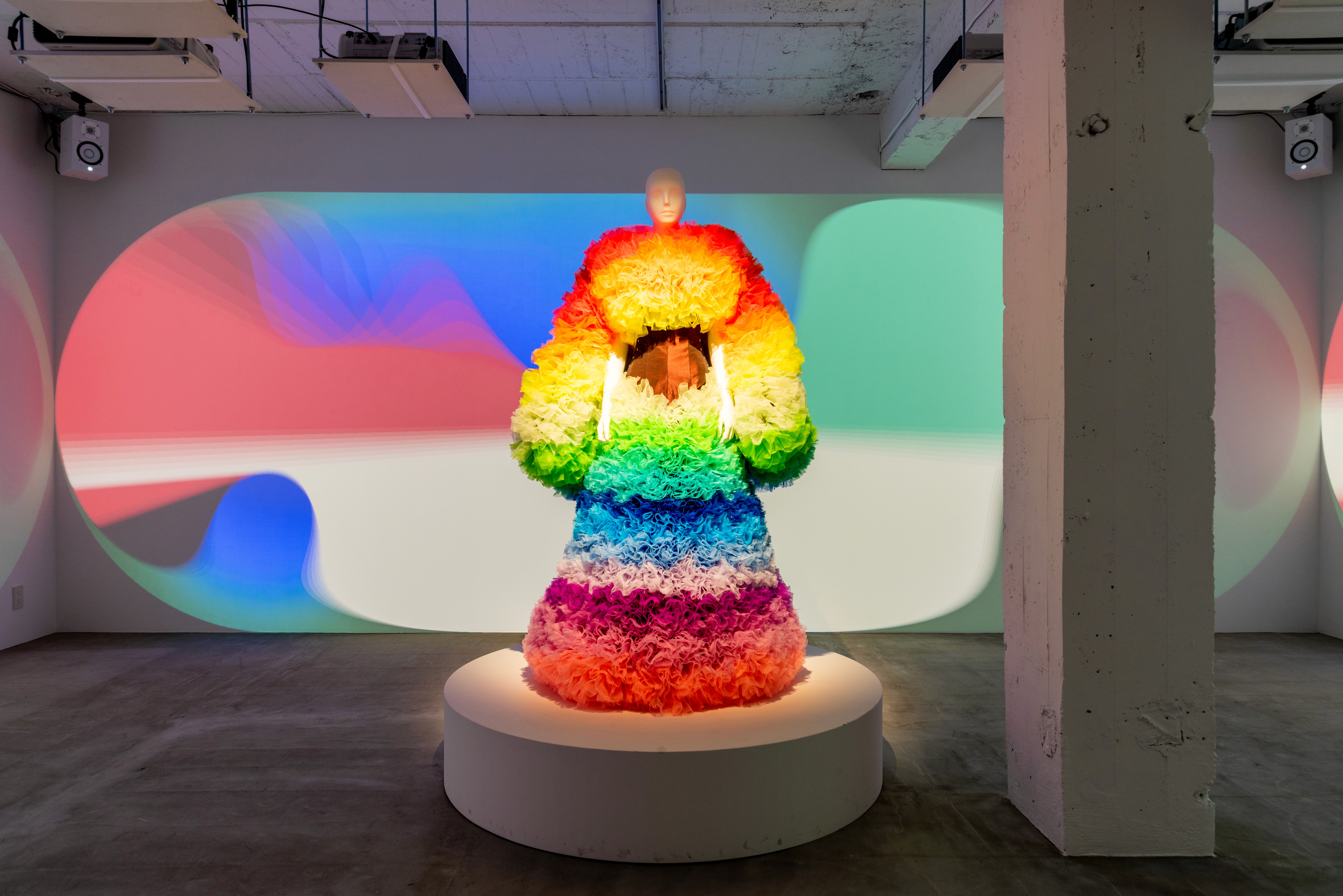 TOMO KOIZUMI-s Rainbow Ruffle Ensemble dress (2022). Presented at Made in Japan 3.0 Defining a New Phy-gital Reality , K11 Art Mall, Hong Kong. Image taken at Sizeless Twin , PARCEL, Tokyo, 2022. Image courtesy of Startbahn.jpg.jpg