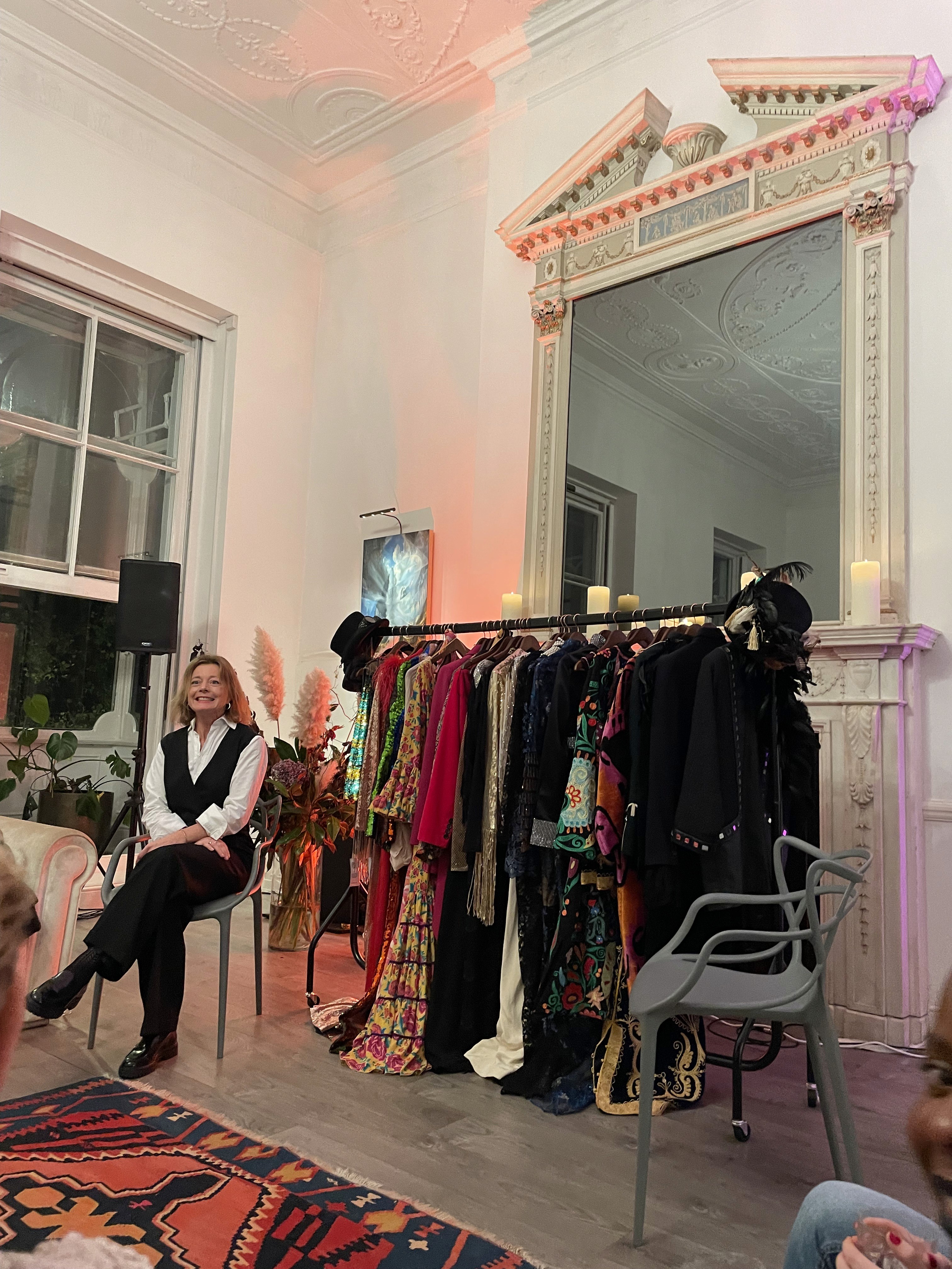 Person seated at a fashion event.