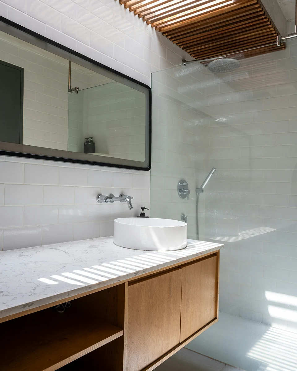 Family room bathroom with a sink and walk-in shower.